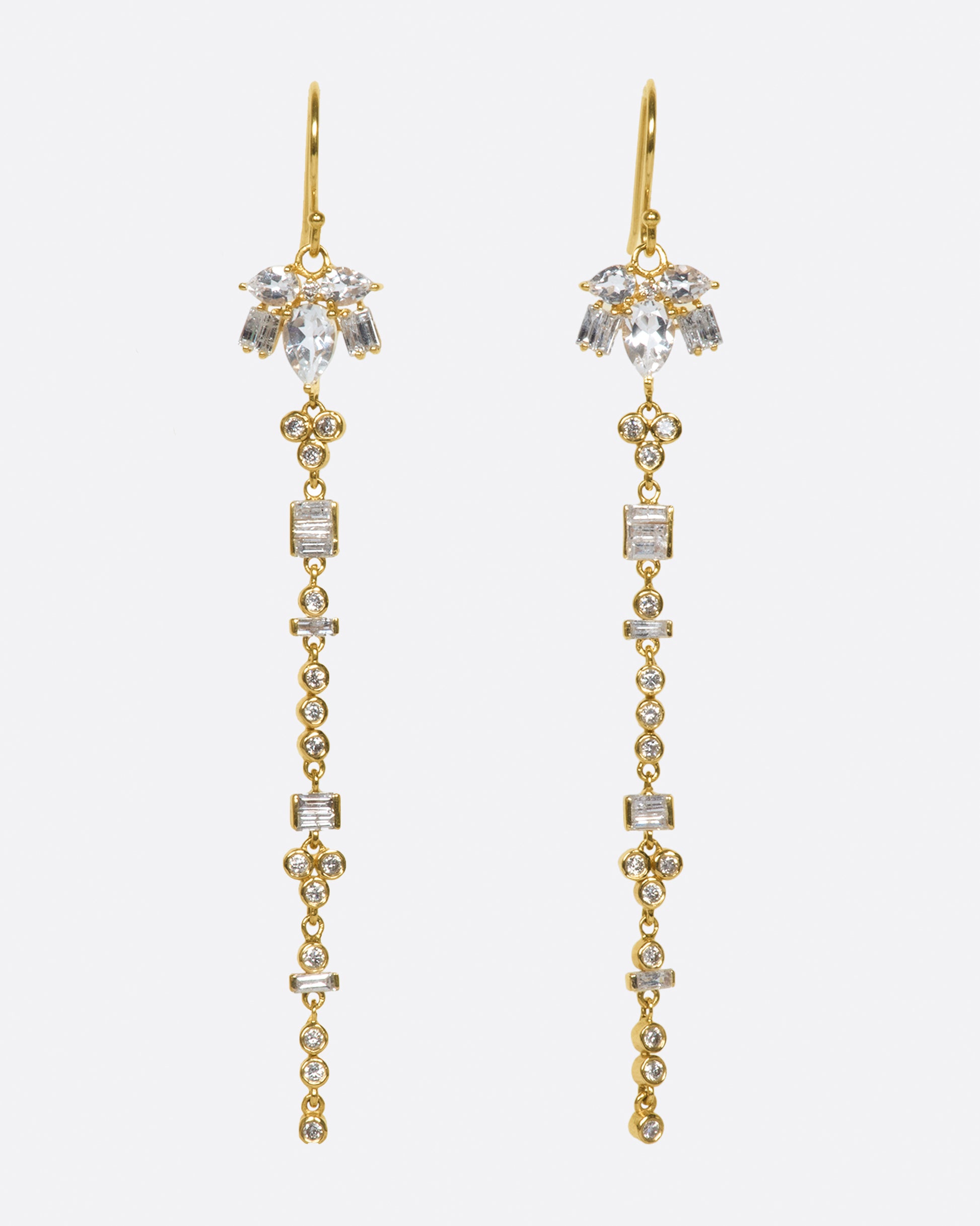 A pair of 14k gold drop earrings with a geometric variety of white topaz and diamonds.