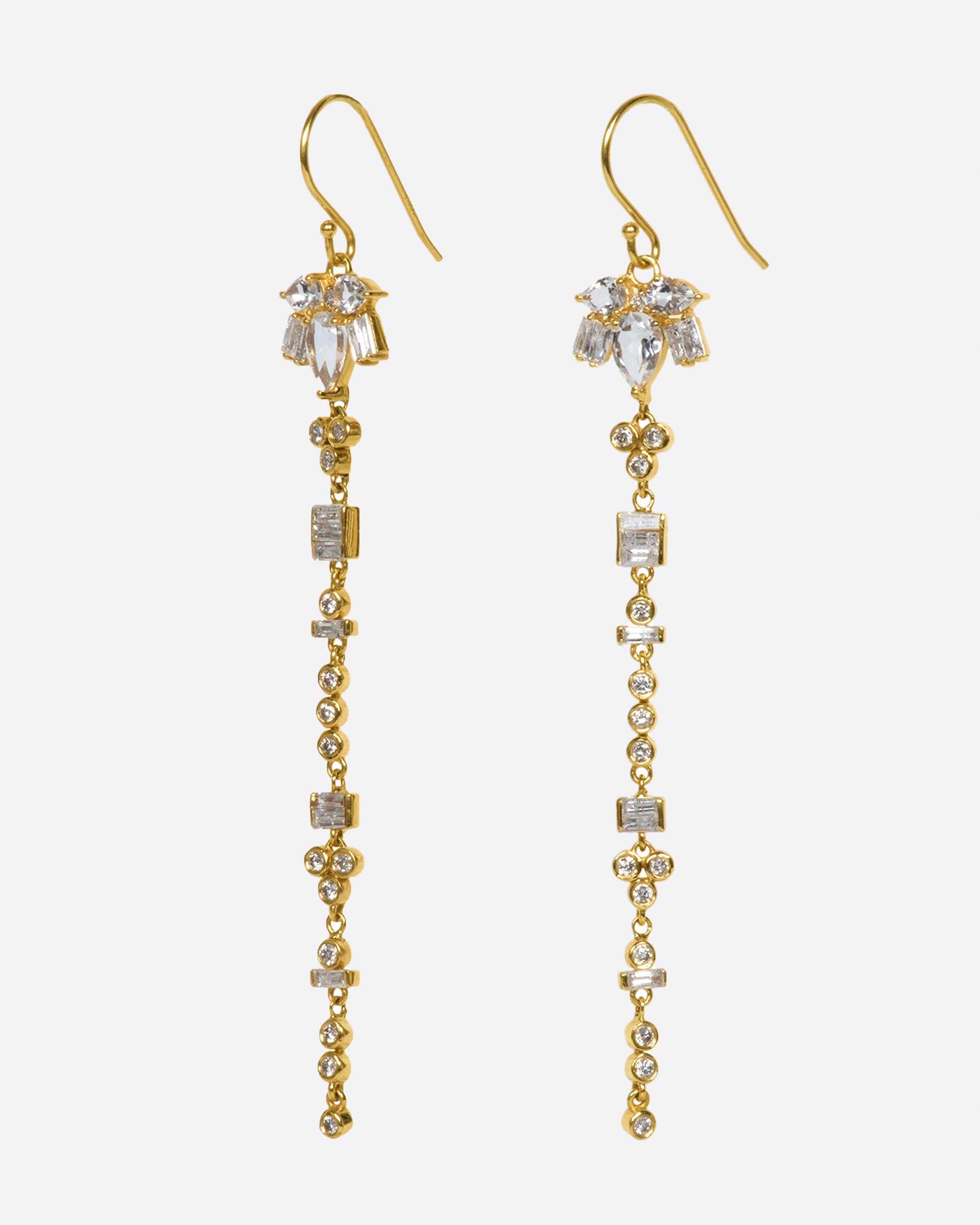 A pair of 14k gold drop earrings with a geometric variety of white topaz and diamonds.