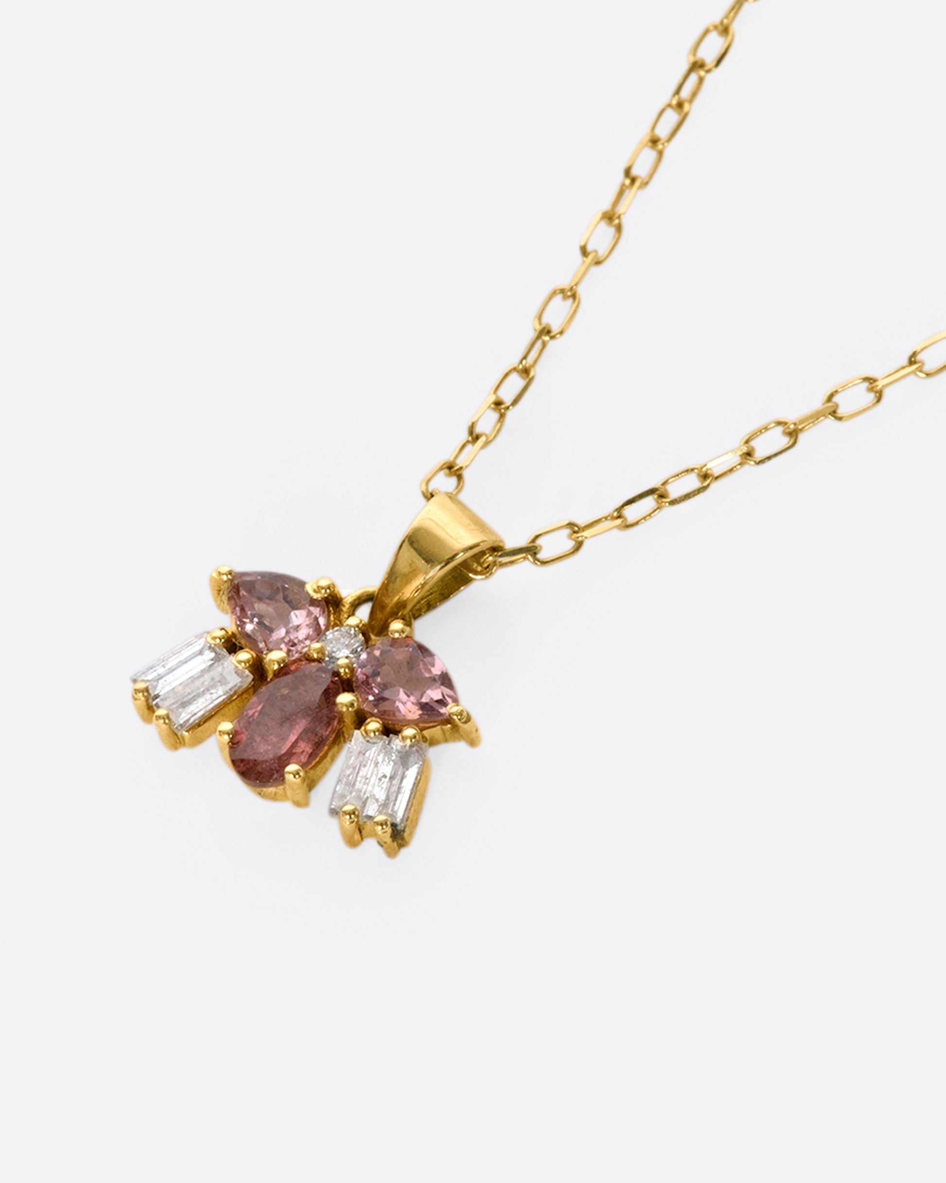 A tiny creature made from tourmalines and diamonds, hanging on a delicate chain.