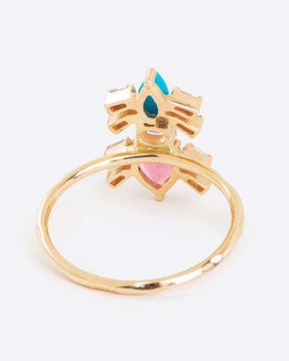 A yellow gold ring with pink tourmalines, turquoise, and baguette diamonds in the shape of an ant. Shown from the back.
