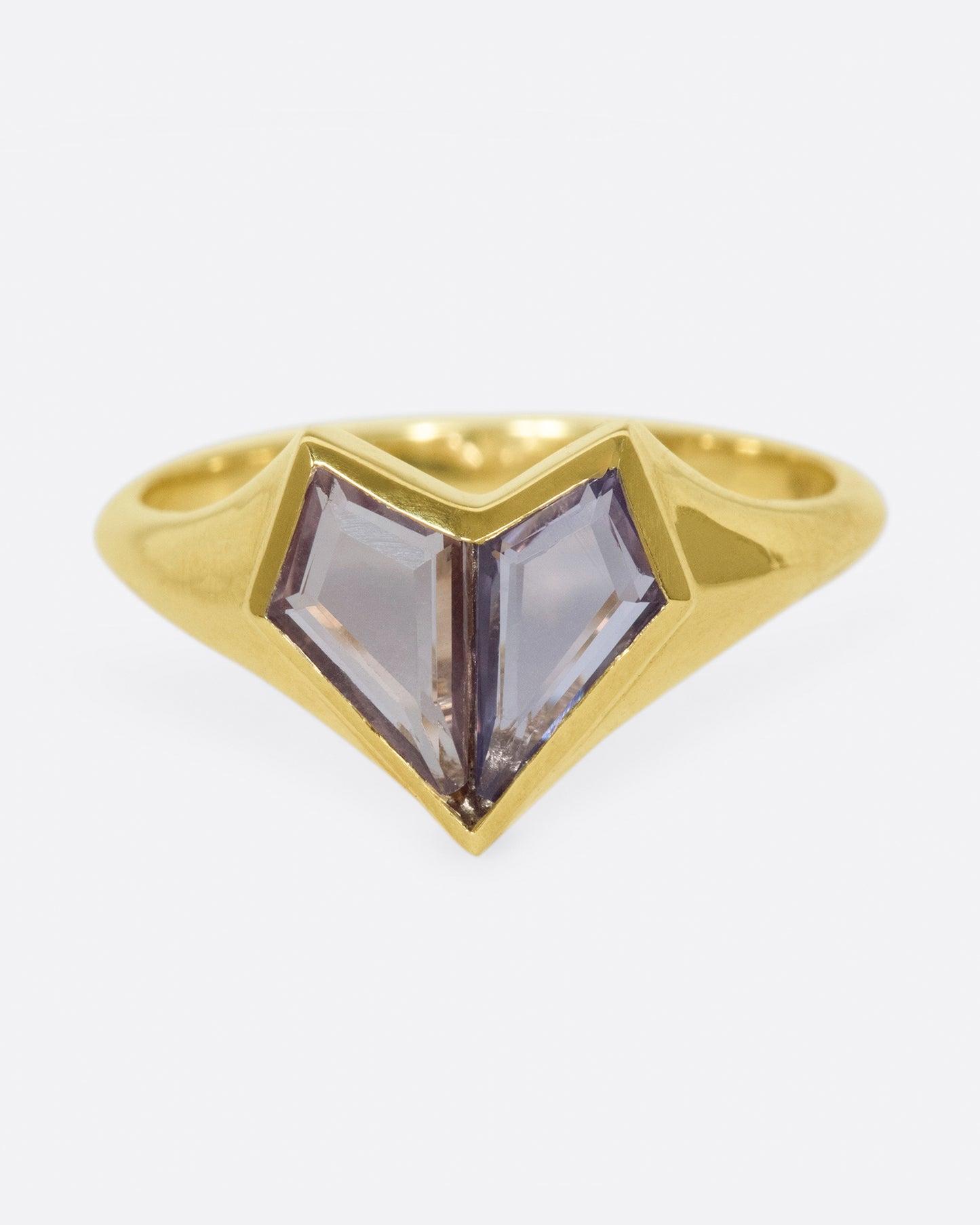 Two kite shaped sapphires; one pale pink and one purple; come together to form a heart on this signet ring.