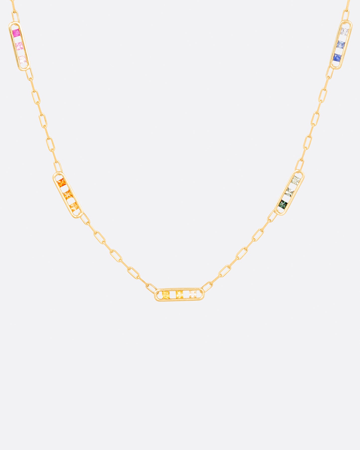 A chain necklace with five stations filled with rainbow ombré sapphires.