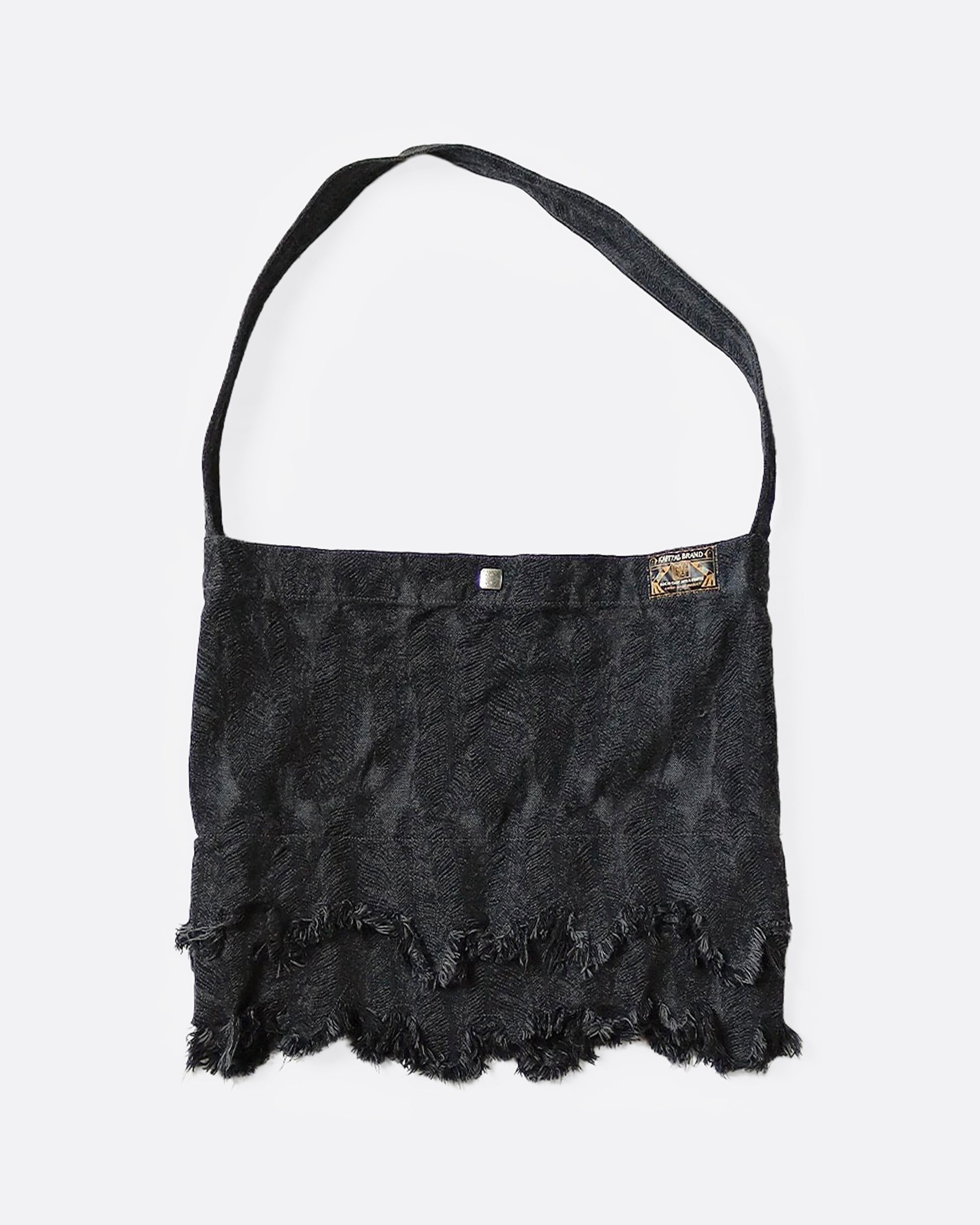 A jacquard denim bag with an all-over 3D feather motif and a cut-off hemline with a raw feathered seam. Shown from the front.