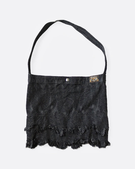 A jacquard denim bag with an all-over 3D feather motif and a cut-off hemline with a raw feathered seam. Shown from the front.