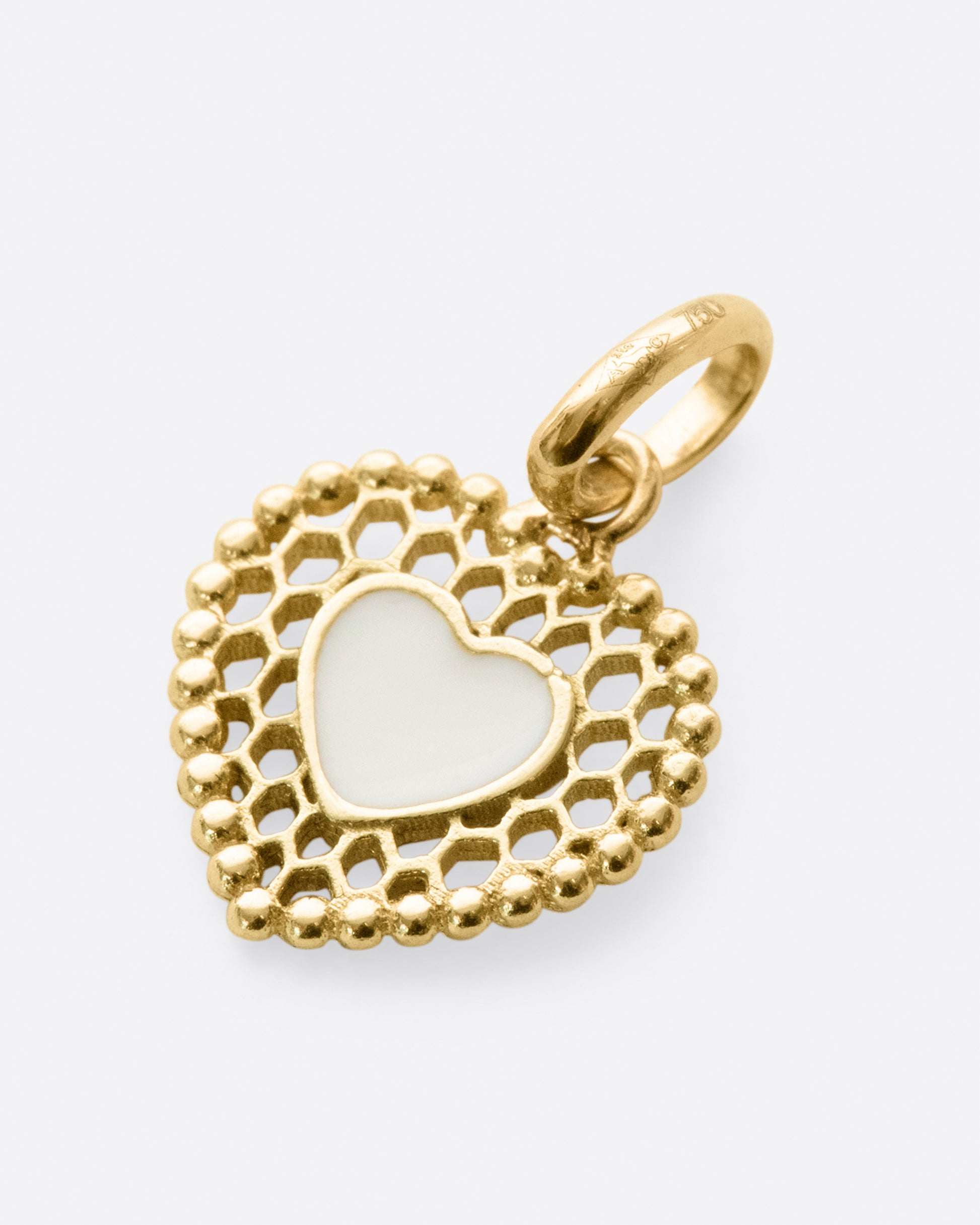 A vintage-inspired heart charm that's still cool and new with its cutout details.