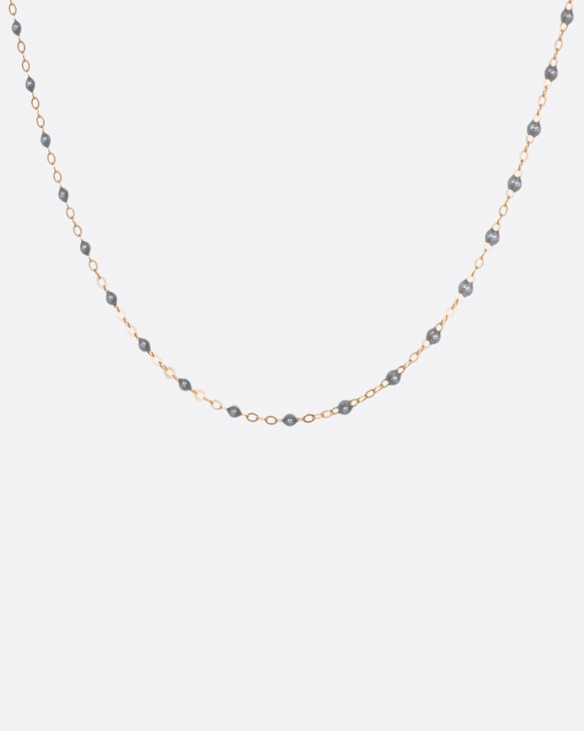 A thin rose gold chain necklace with resin beads. Each necklace is hand dipped in melted resin to create the beaded effect. 