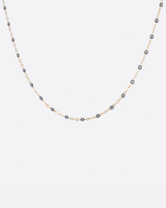 A thin rose gold chain necklace with resin beads. Each necklace is hand dipped in melted resin to create the beaded effect. 