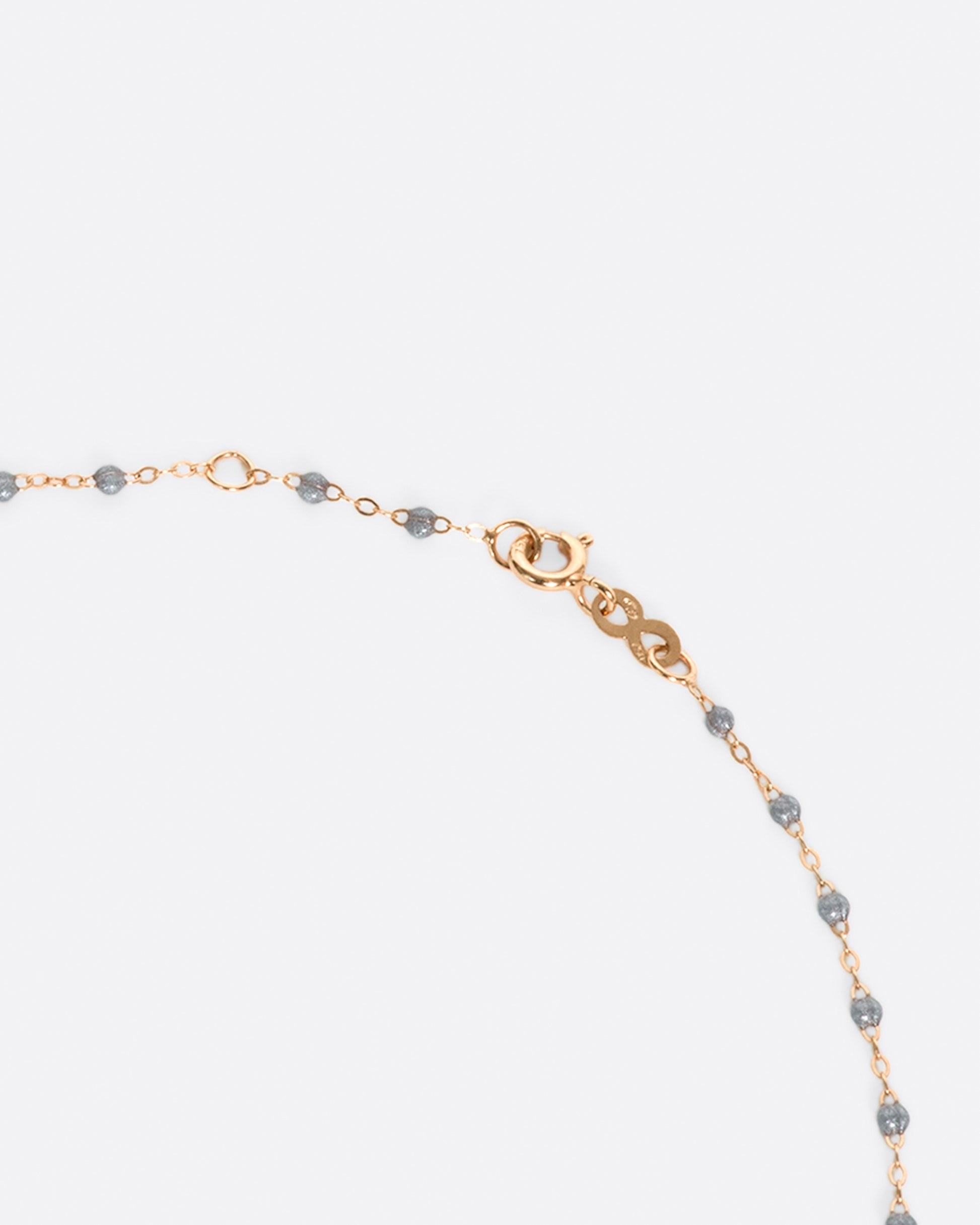 A thin rose gold chain necklace with resin beads. Each necklace is hand dipped in melted resin to create the beaded effect. 