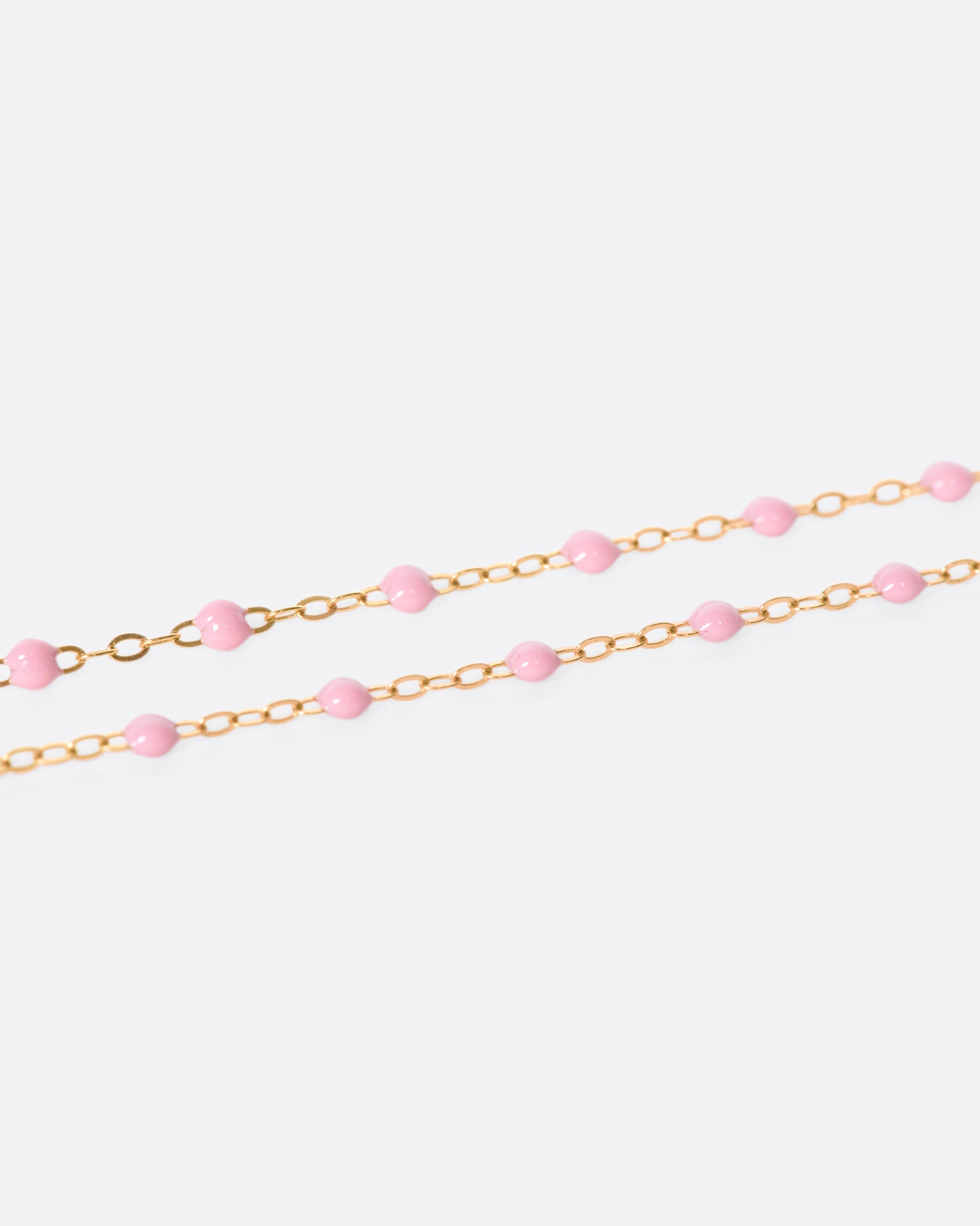 A thin rose gold chain necklace with resin beads. Each necklace is hand dipped in melted resin to create the beaded effect. 