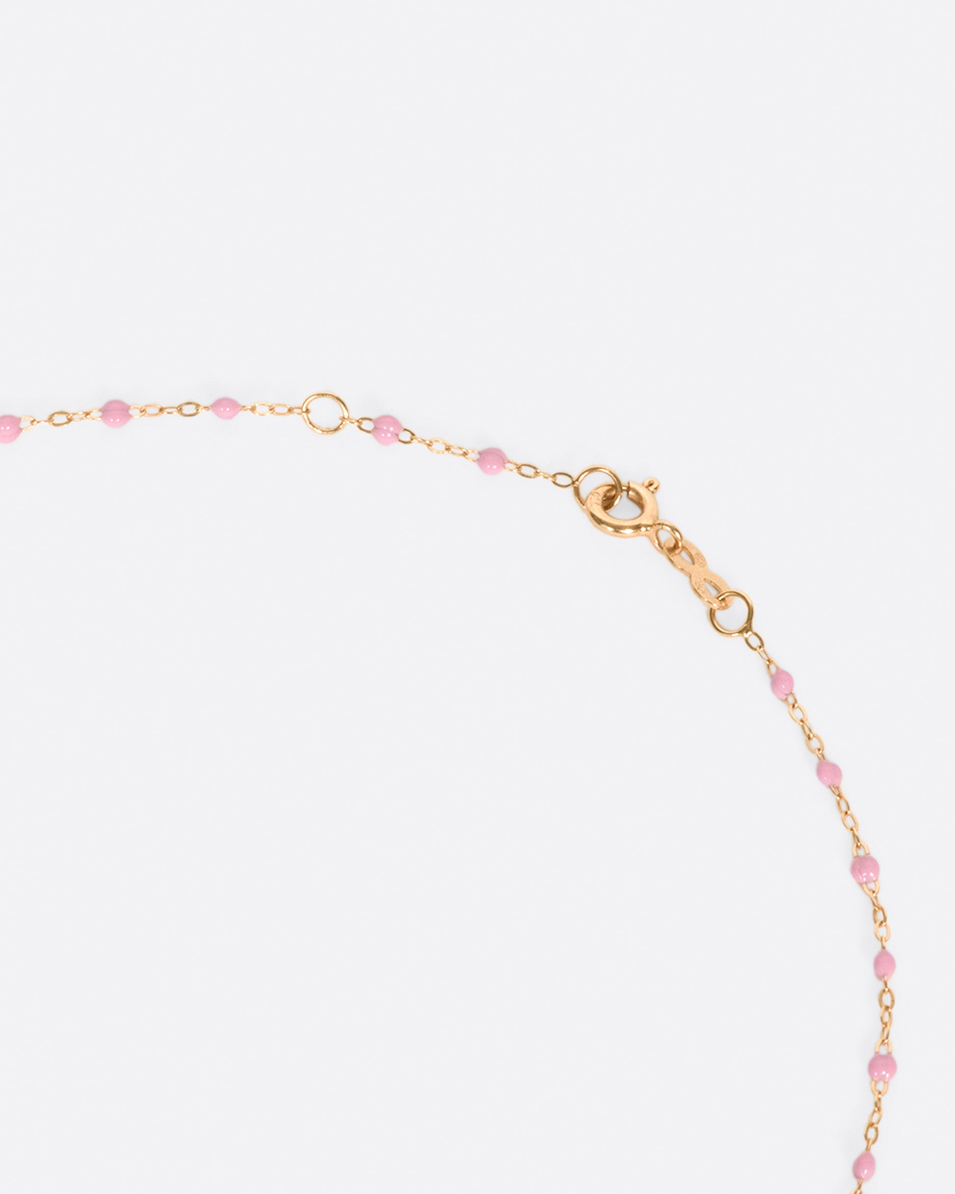 A thin rose gold chain necklace with resin beads. Each necklace is hand dipped in melted resin to create the beaded effect. 