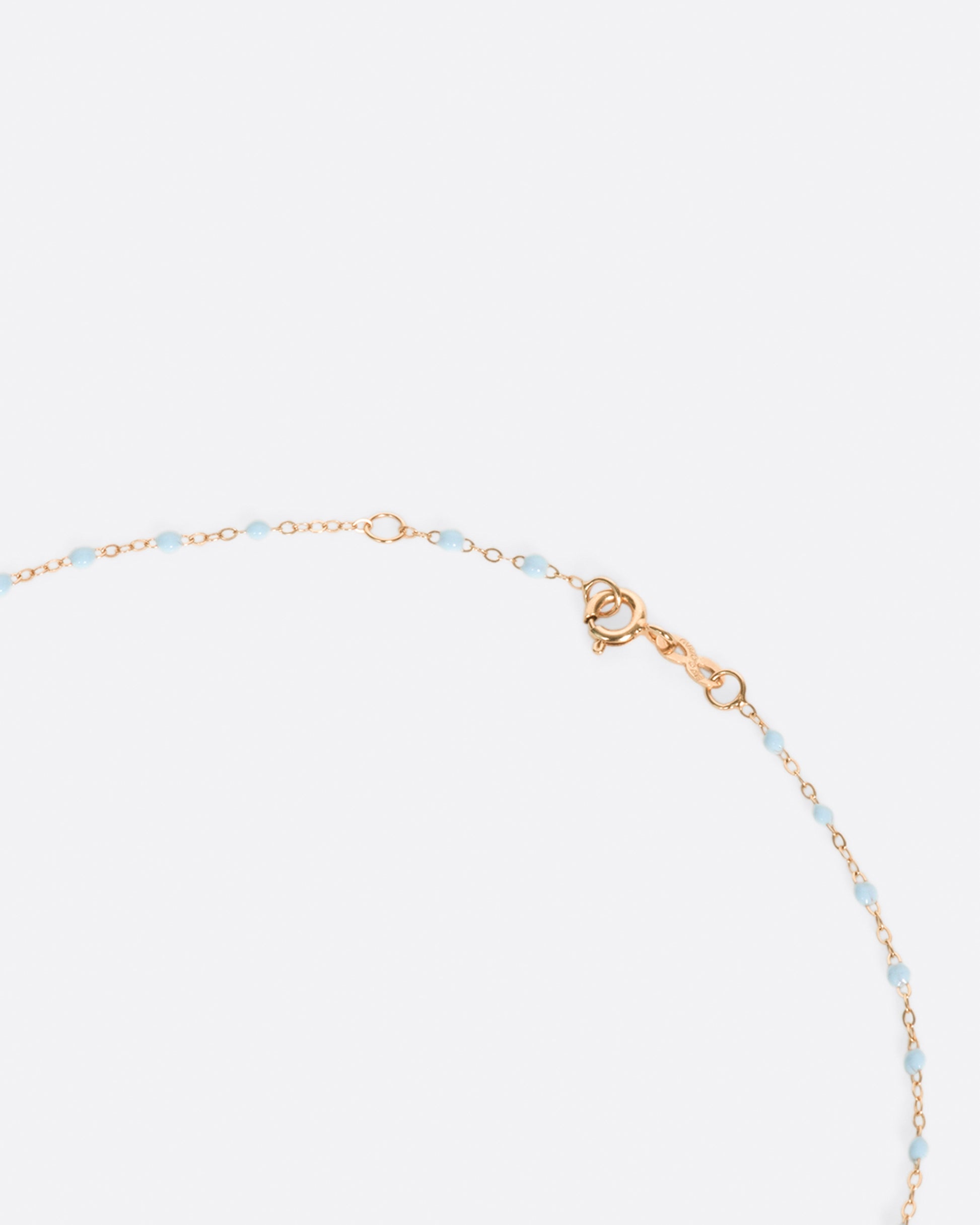 A thin rose gold chain necklace with resin beads. Each necklace is hand dipped in melted resin to create the beaded effect. 