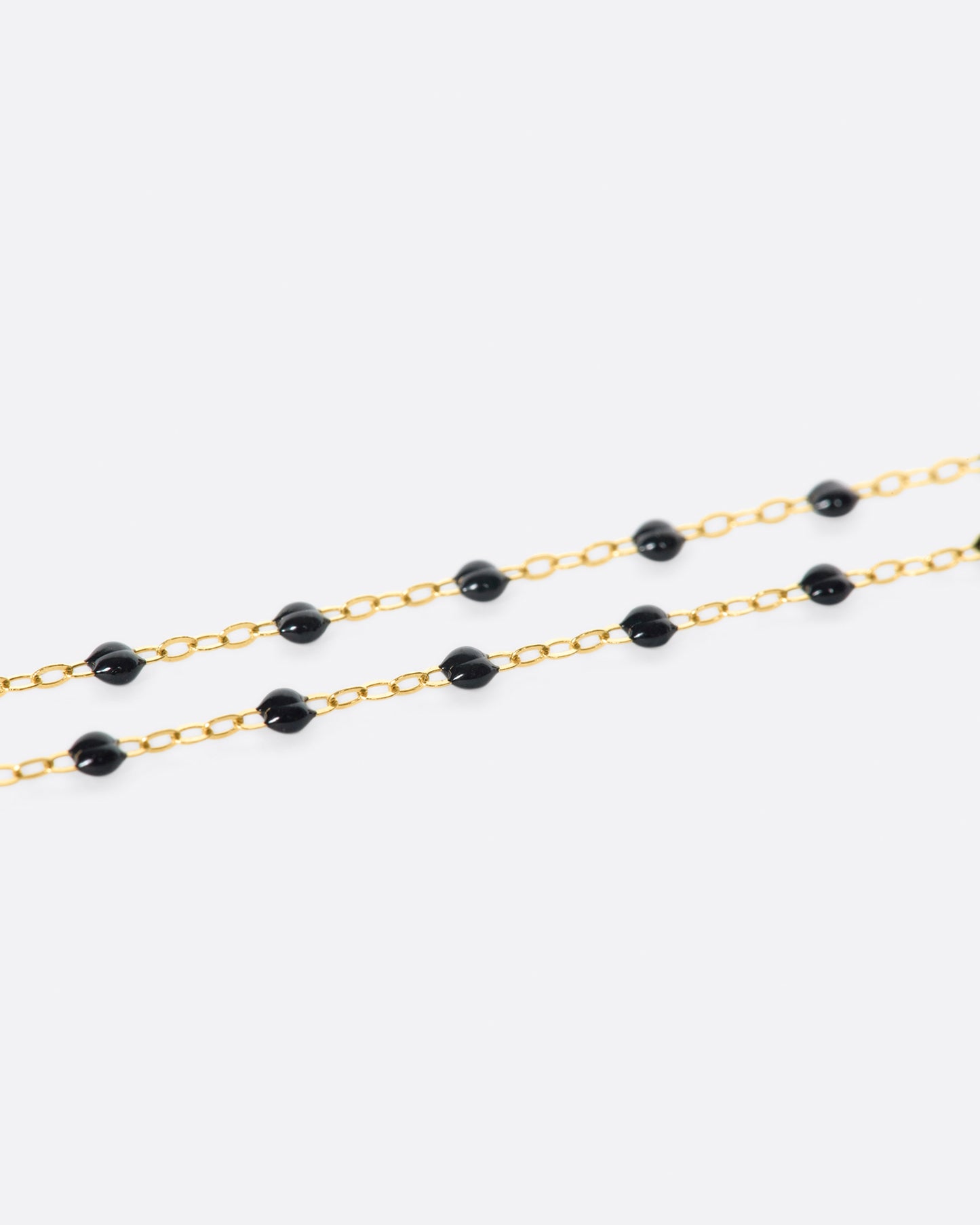 Thin 18k yellow gold chain necklace with resin beads. Each necklace is hand dipped in melted resin to create the beaded effect. 