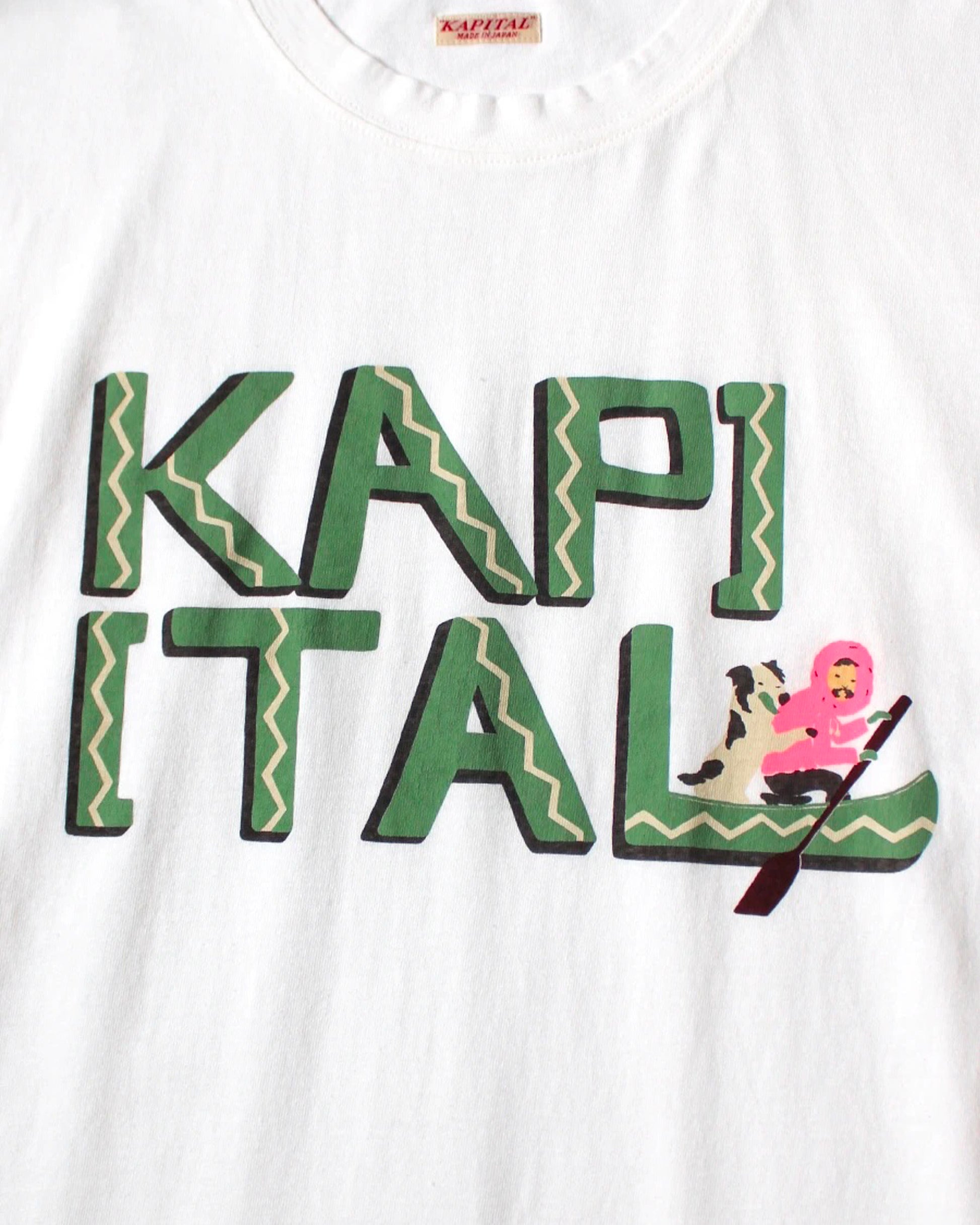 A white t-shirt with hand-drawn lettering reading 'Kapital' and a canoe graphic, shown from the front.