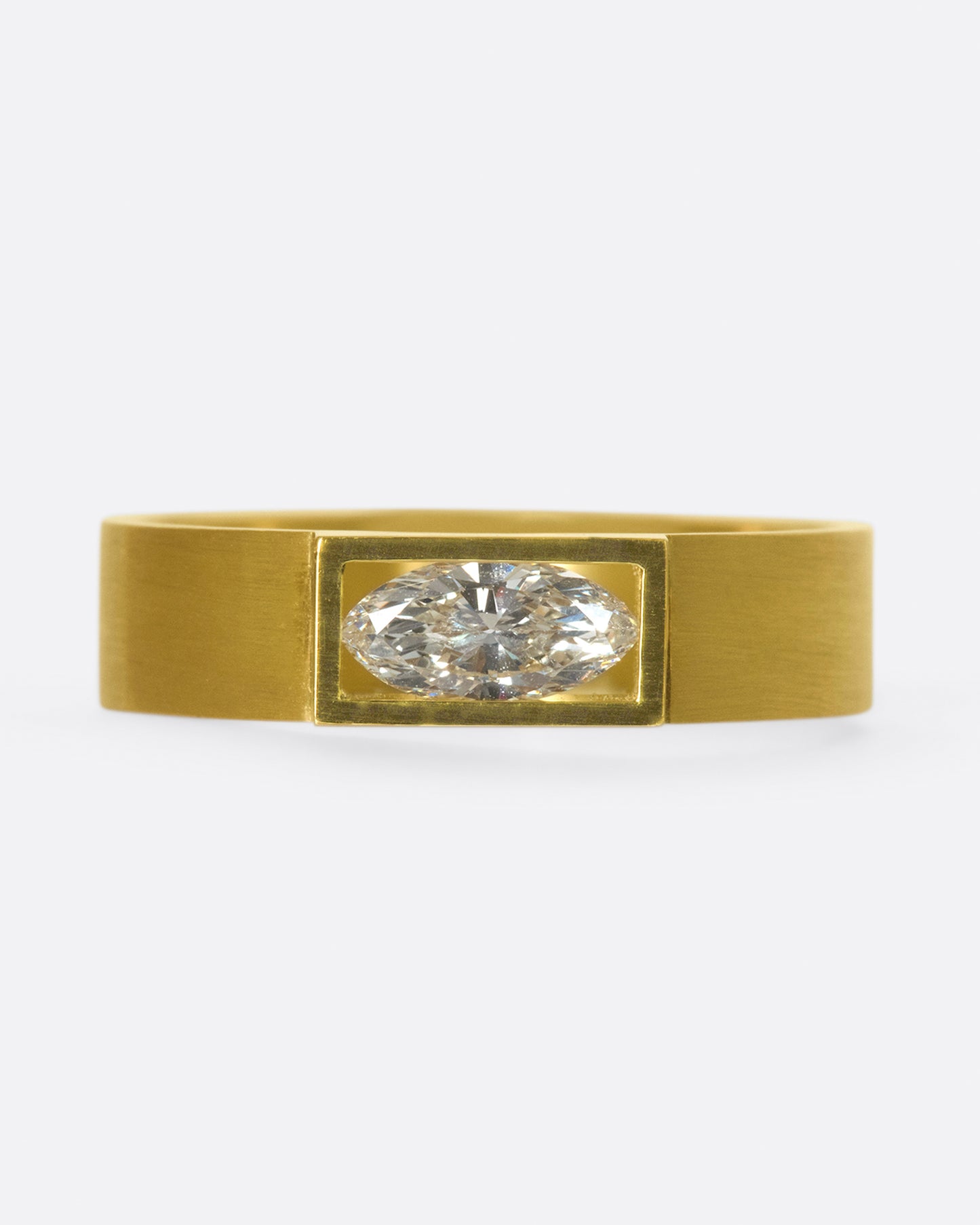 A matte band with marquise diamond set east-west at its center.