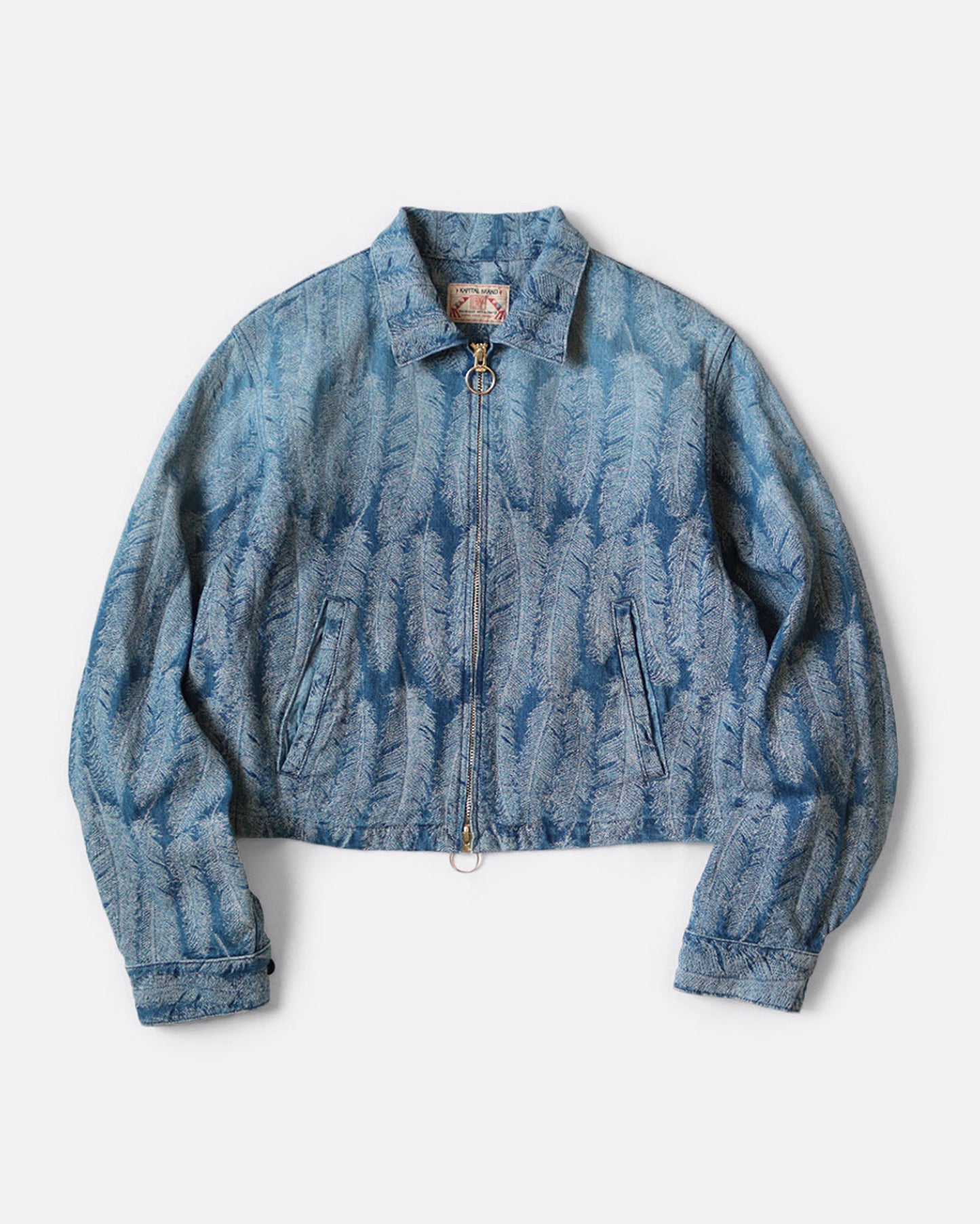 A light blue jacquard denim jacket with  an all- over feather motif, and a cut-off hemline with raw feathered seam. Shown from the front.