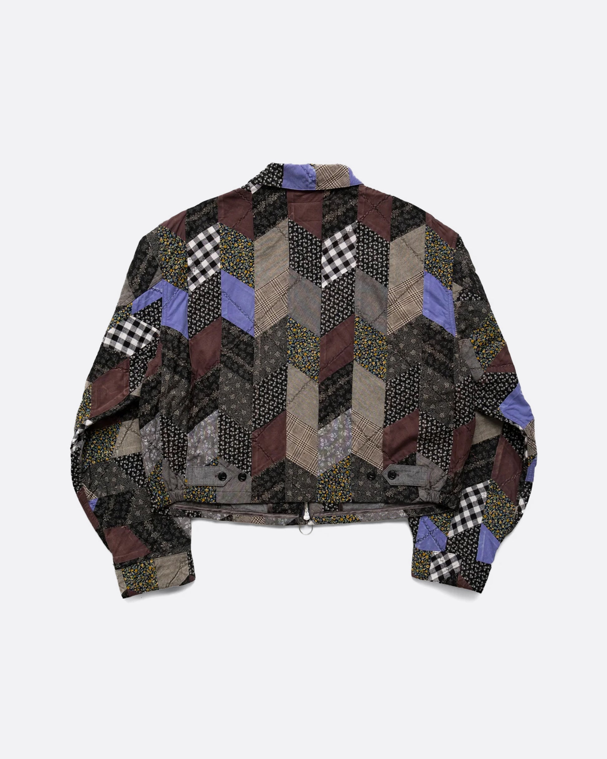 A cropped jacket with an arrow shaped patchwork and zip front. Shown from the back.