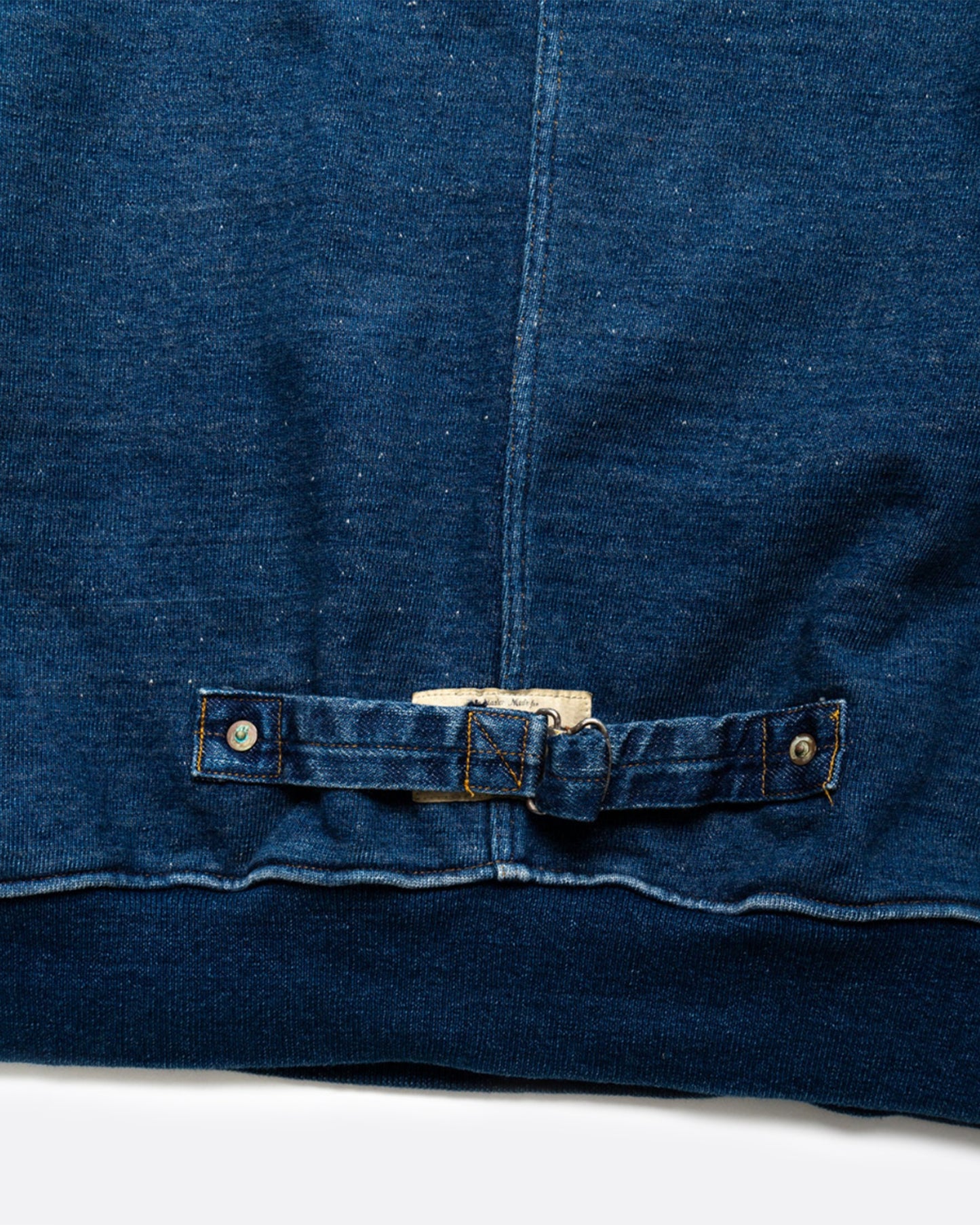 A loose fitting, indigo fleece sweatshirt with a T-shaped split back and cinch.