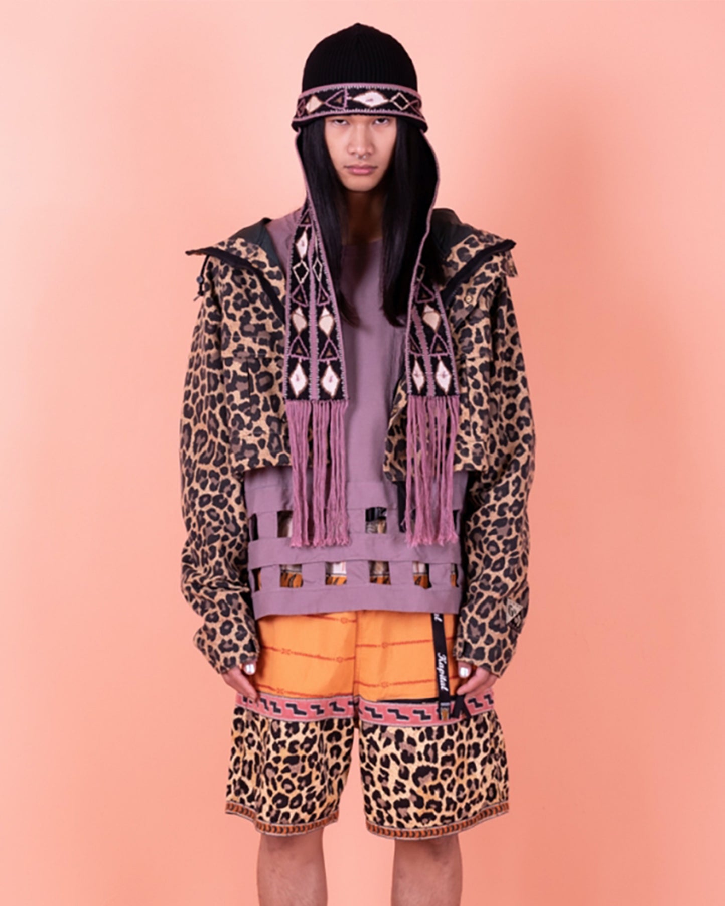 Cropped leopard rain jacket with hood and two front pockets. View on a person.