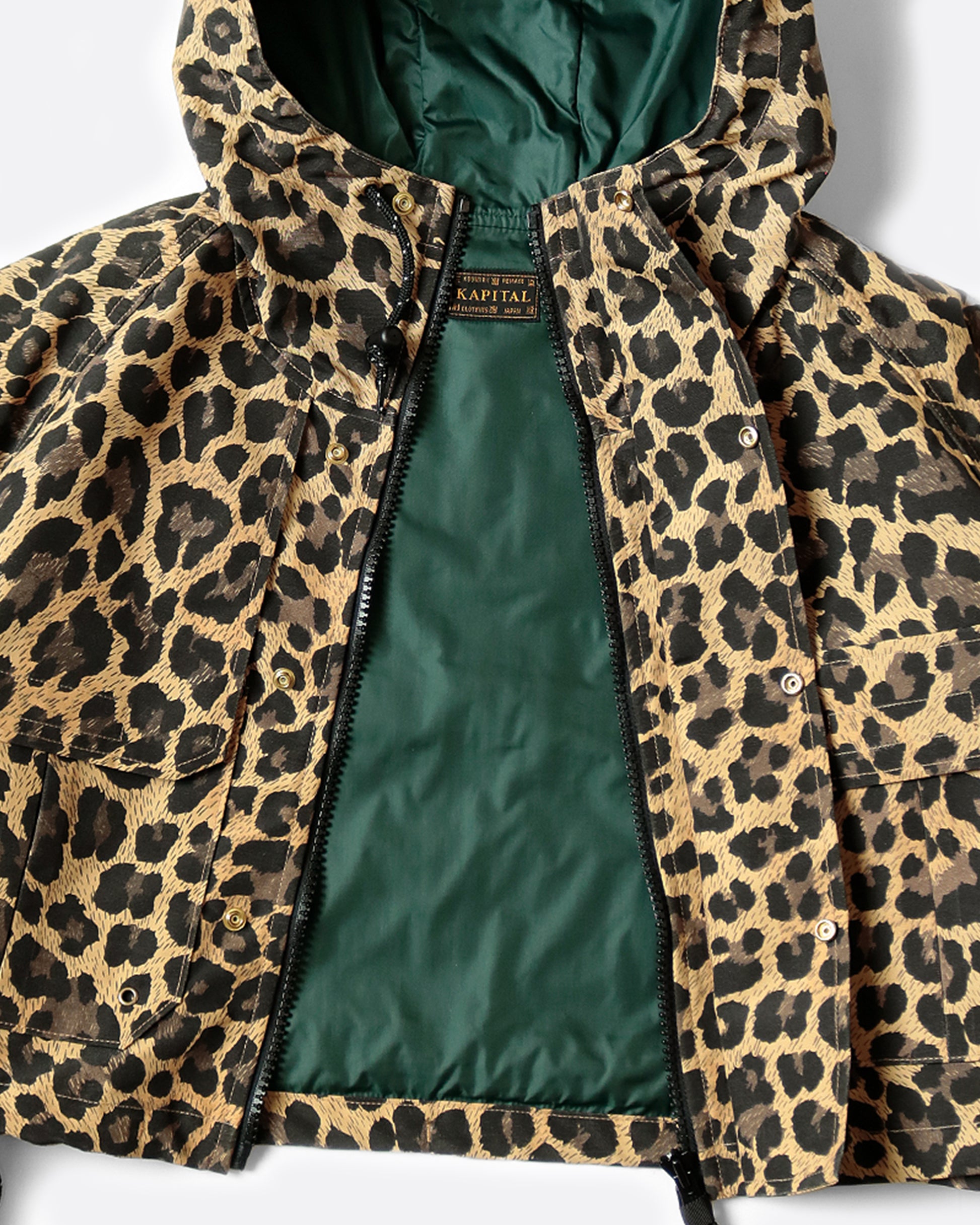 Cropped leopard rain jacket with hood and two front pockets. View from the front, unzipped.