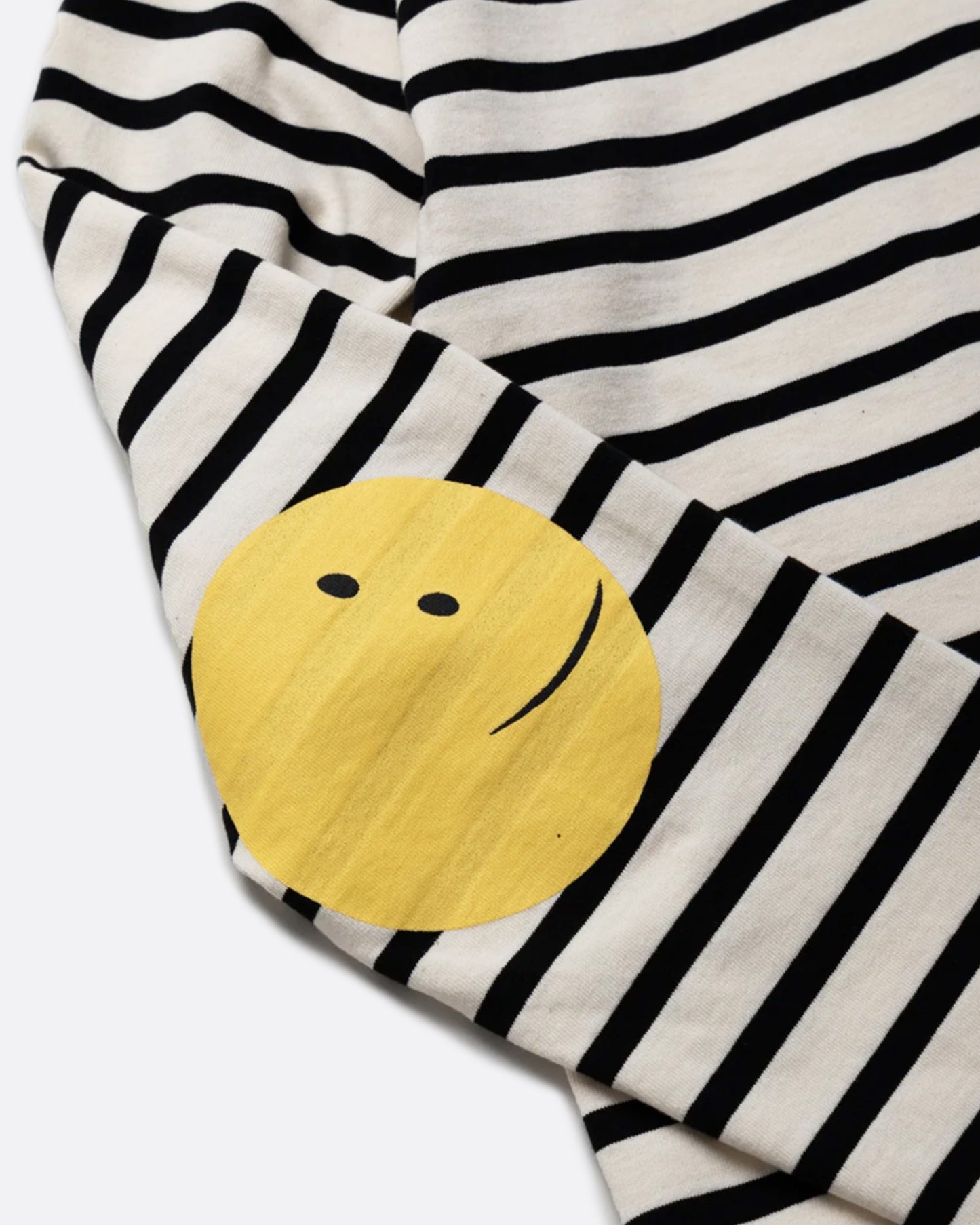 A black and cream striped, cotton, crewneck shirt with Kapital's fan favorite rainbow smiley elbow patches.