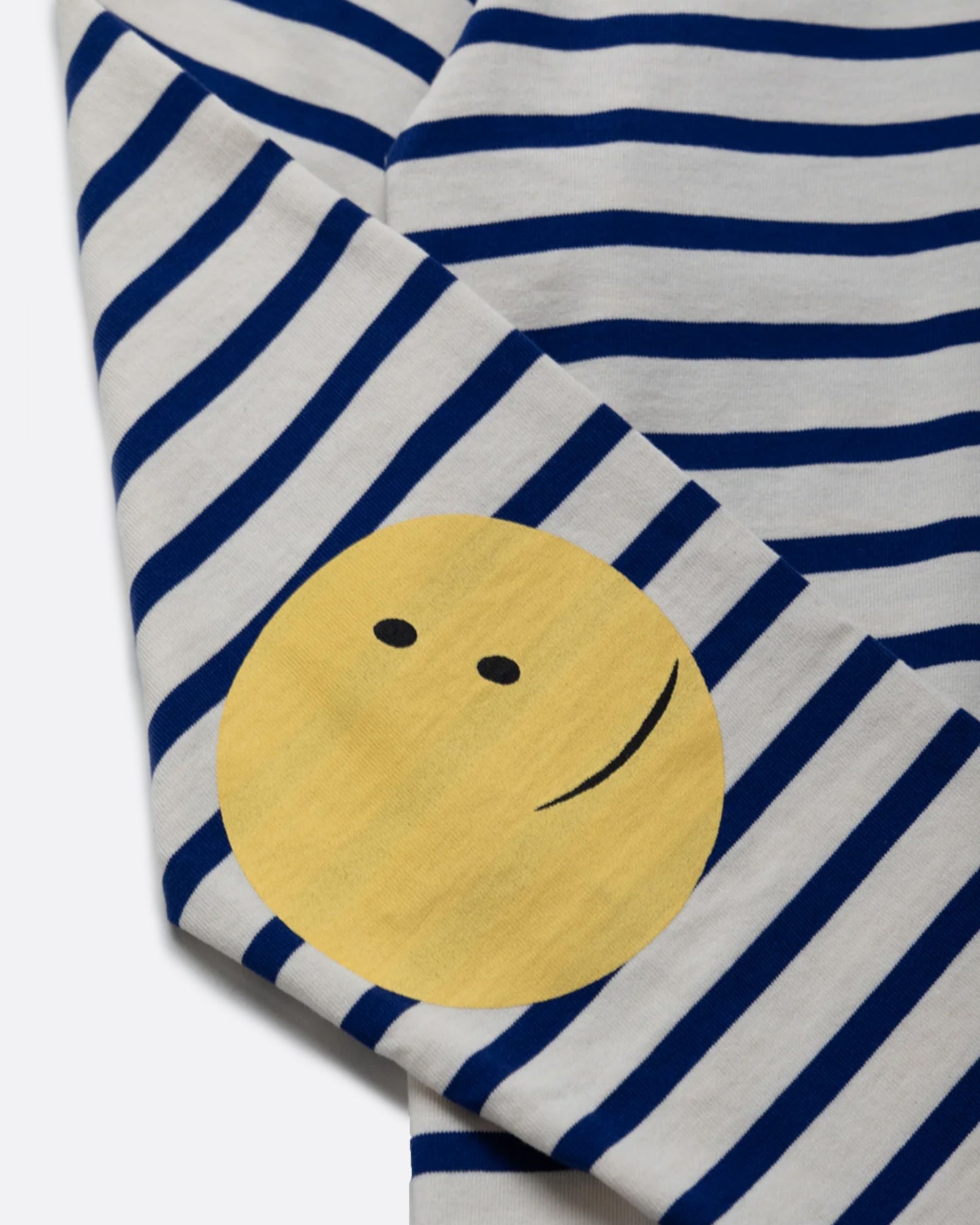 A blue and white striped, cotton, crewneck shirt with Kapital's fan favorite rainbow smiley elbow patches.