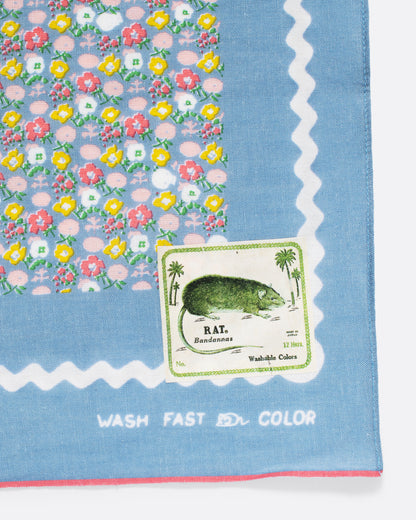 Light blue skull and flower print bandana, close view of the corner and label