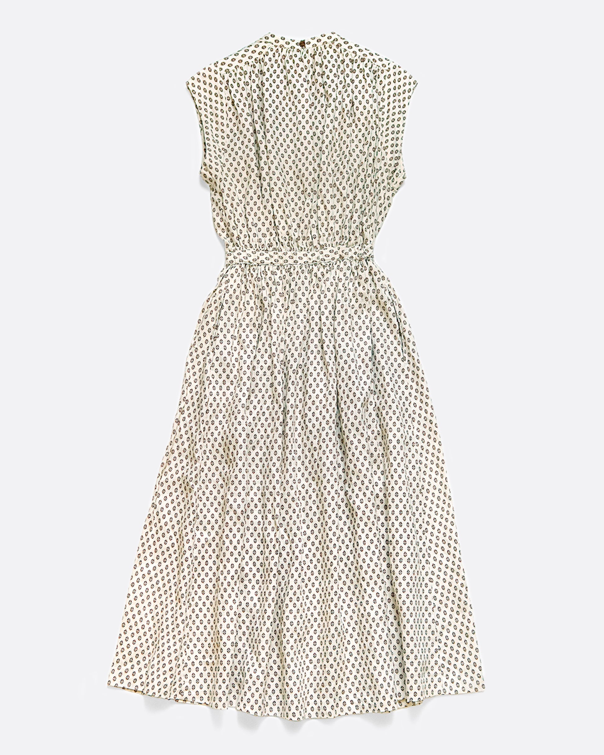 A sleeveless dress with a small ethnic pattern. It has a clean neckline with gathers across the bust and an elastic waist. View from the back.