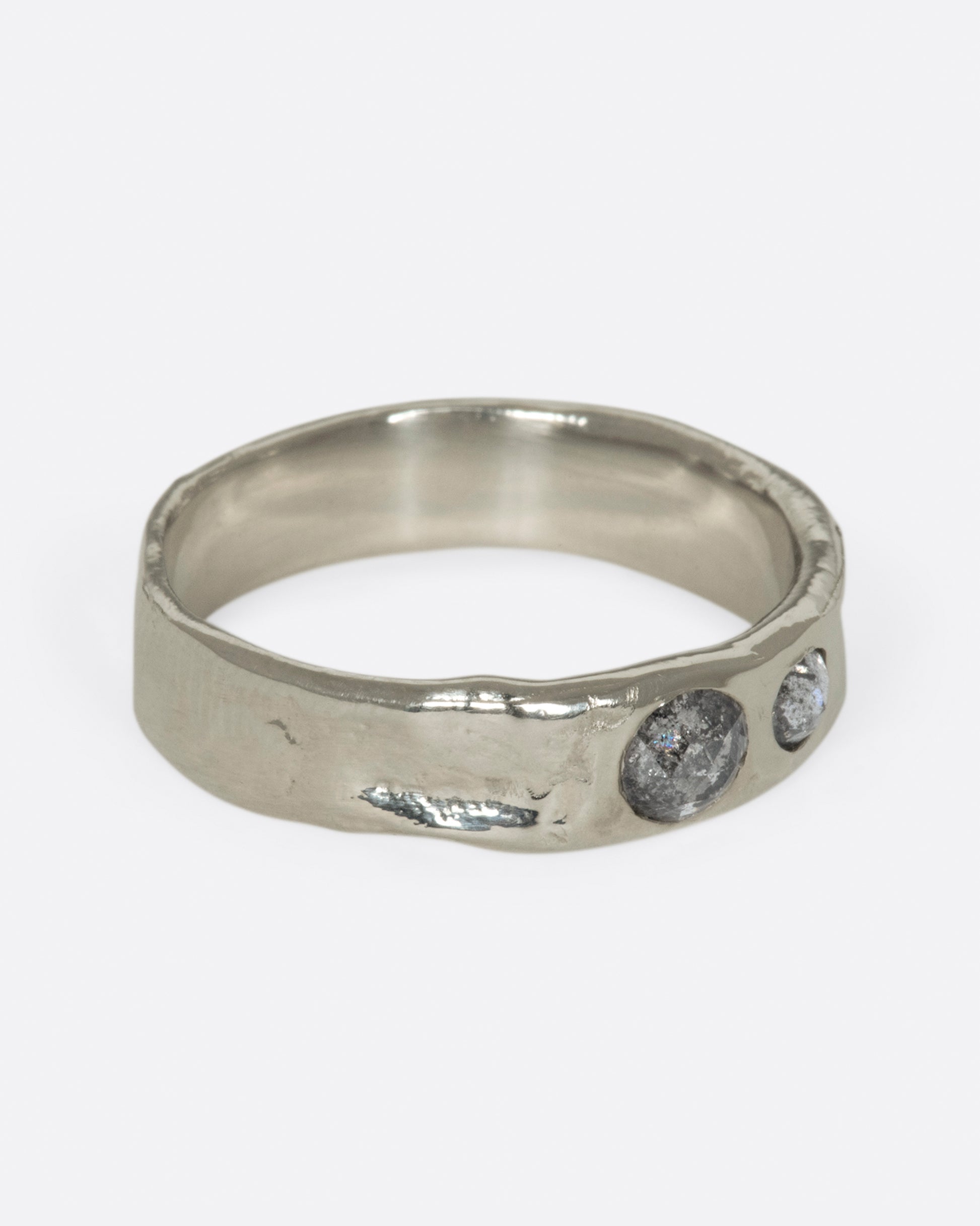 Medium wide band with light texture, featuring two rose cut salt & pepper diamonds flush to the band. 