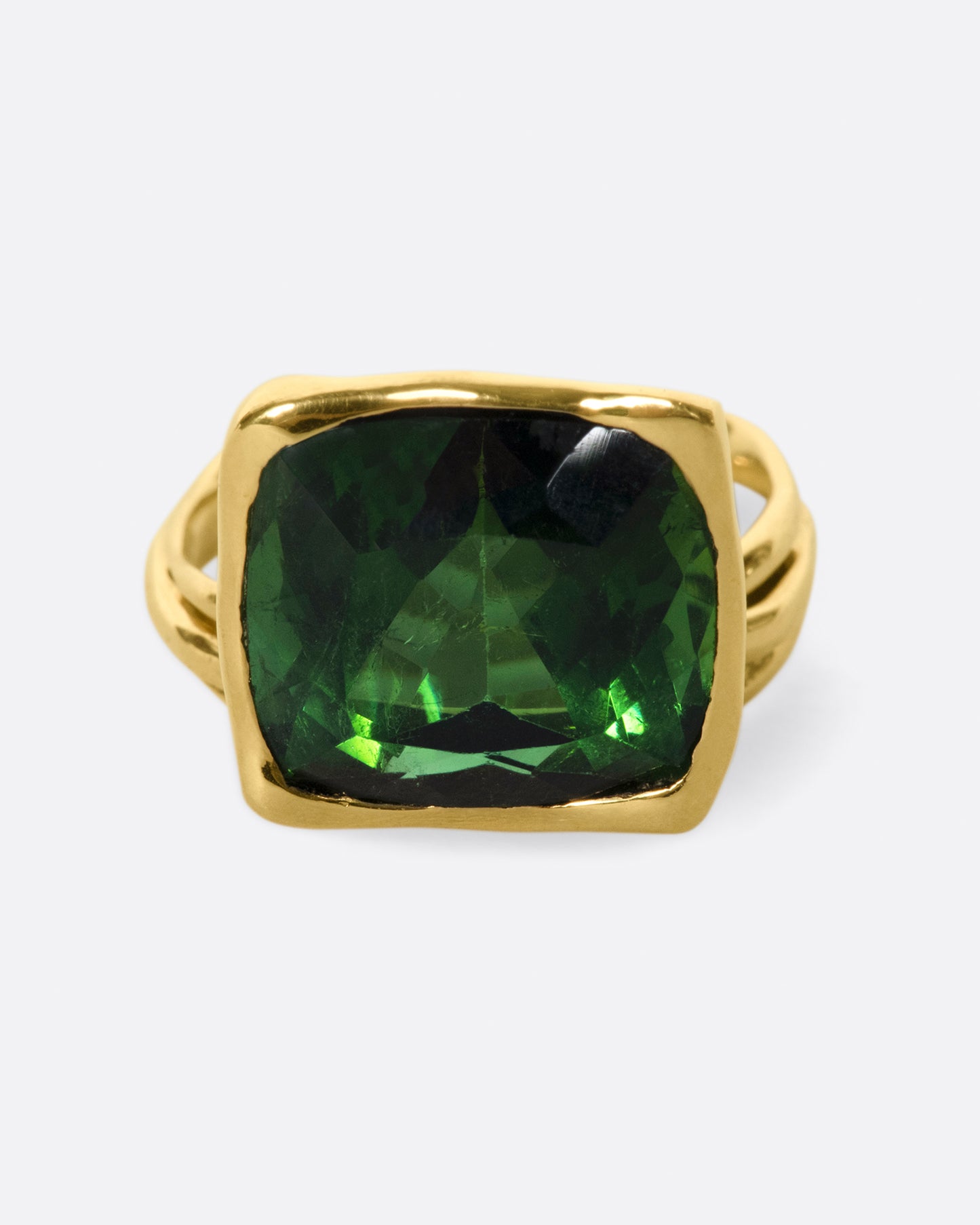 This ring is designed to showcase the tourmaline; the band is set off to one side and the setting is raised to allow for maximum light to pass through the stone.