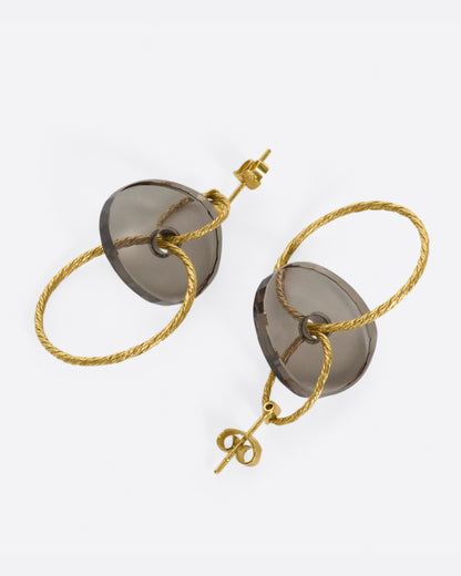 Yellow gold and smoky quartz hoop earrings, the pair laid flat showing the posts and backs