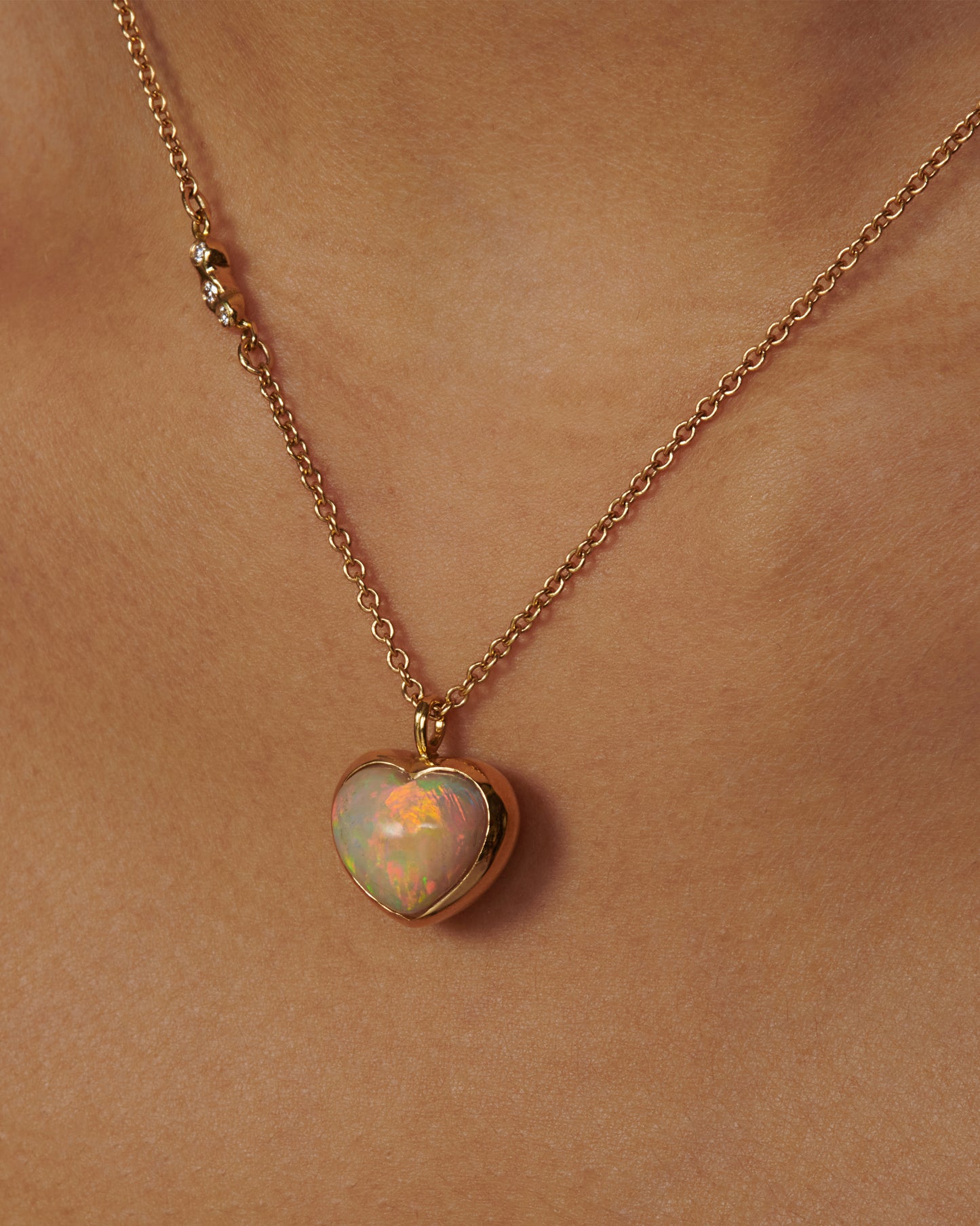 A glorious, bubble-like, Australian opal heart pendant whose fire can be seen from every angle.