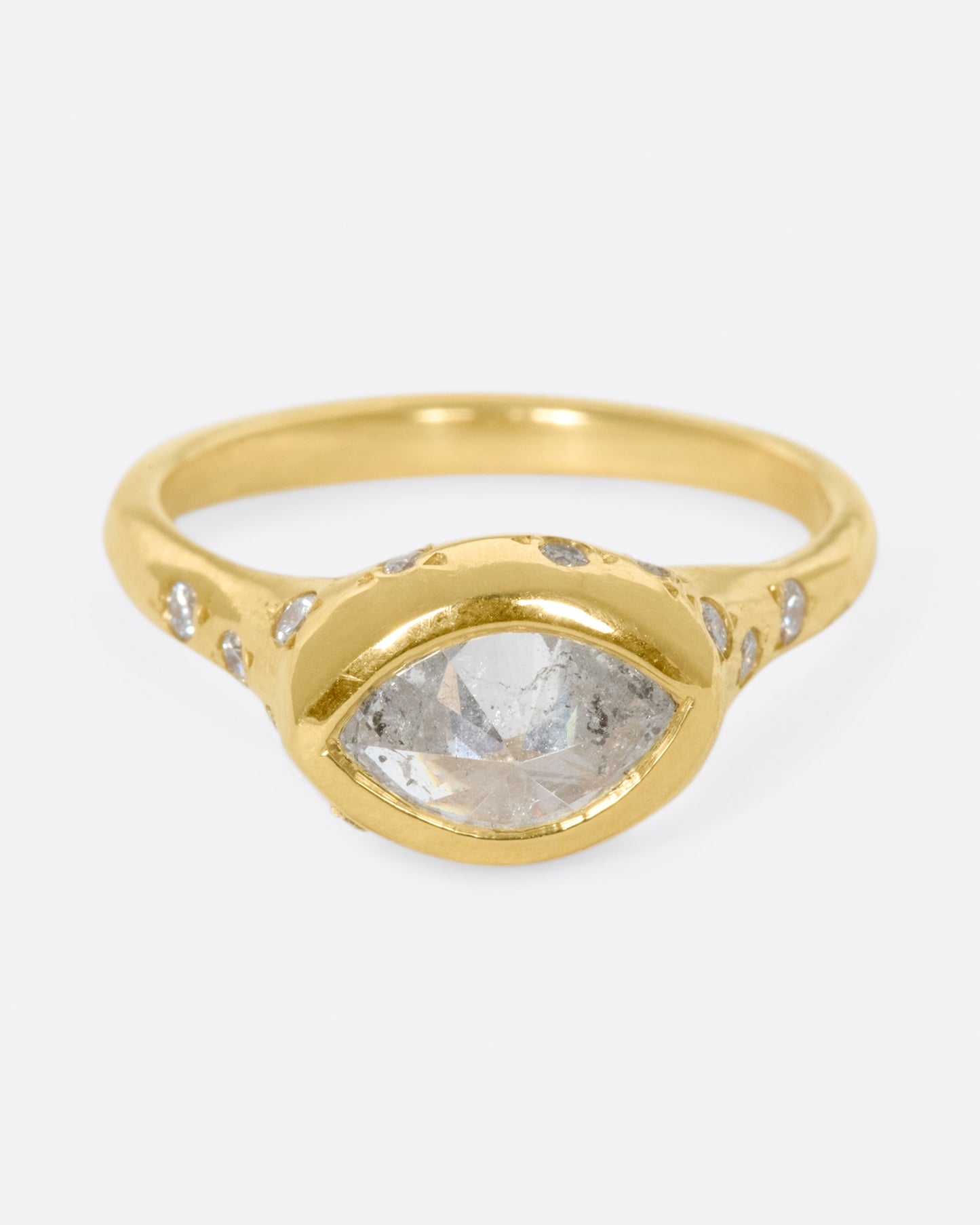 This ring is made extra special by the inverted, east-west diamond at its center.