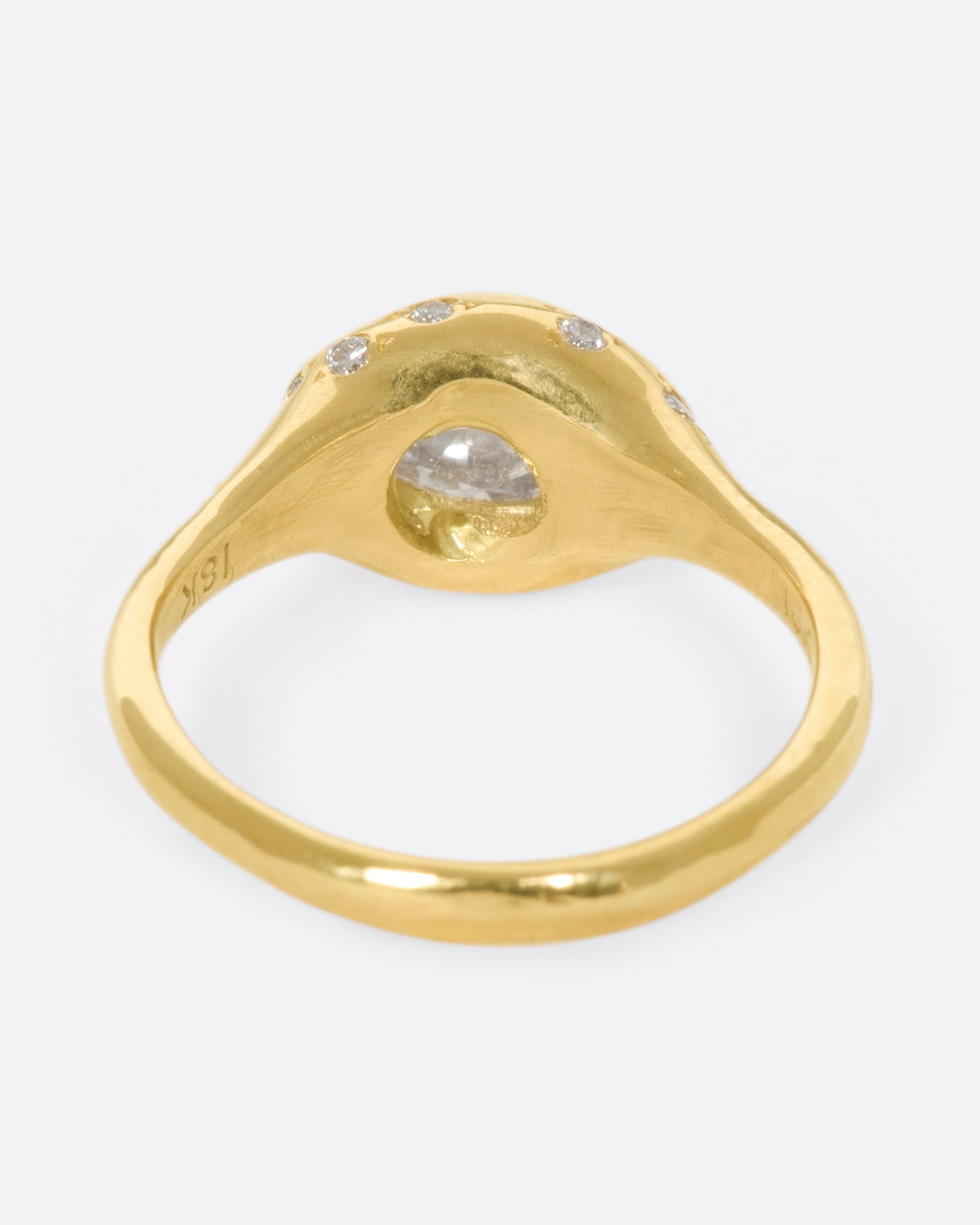 This ring is made extra special by the inverted, east-west diamond at its center.