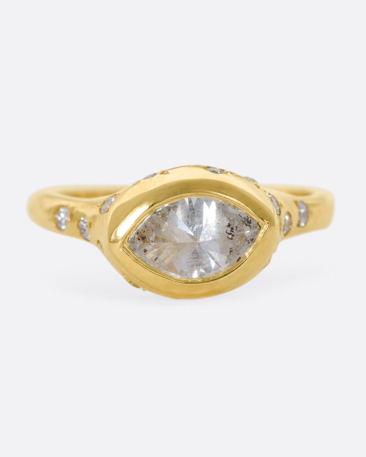 This ring is made extra special by the inverted, east-west diamond at its center.