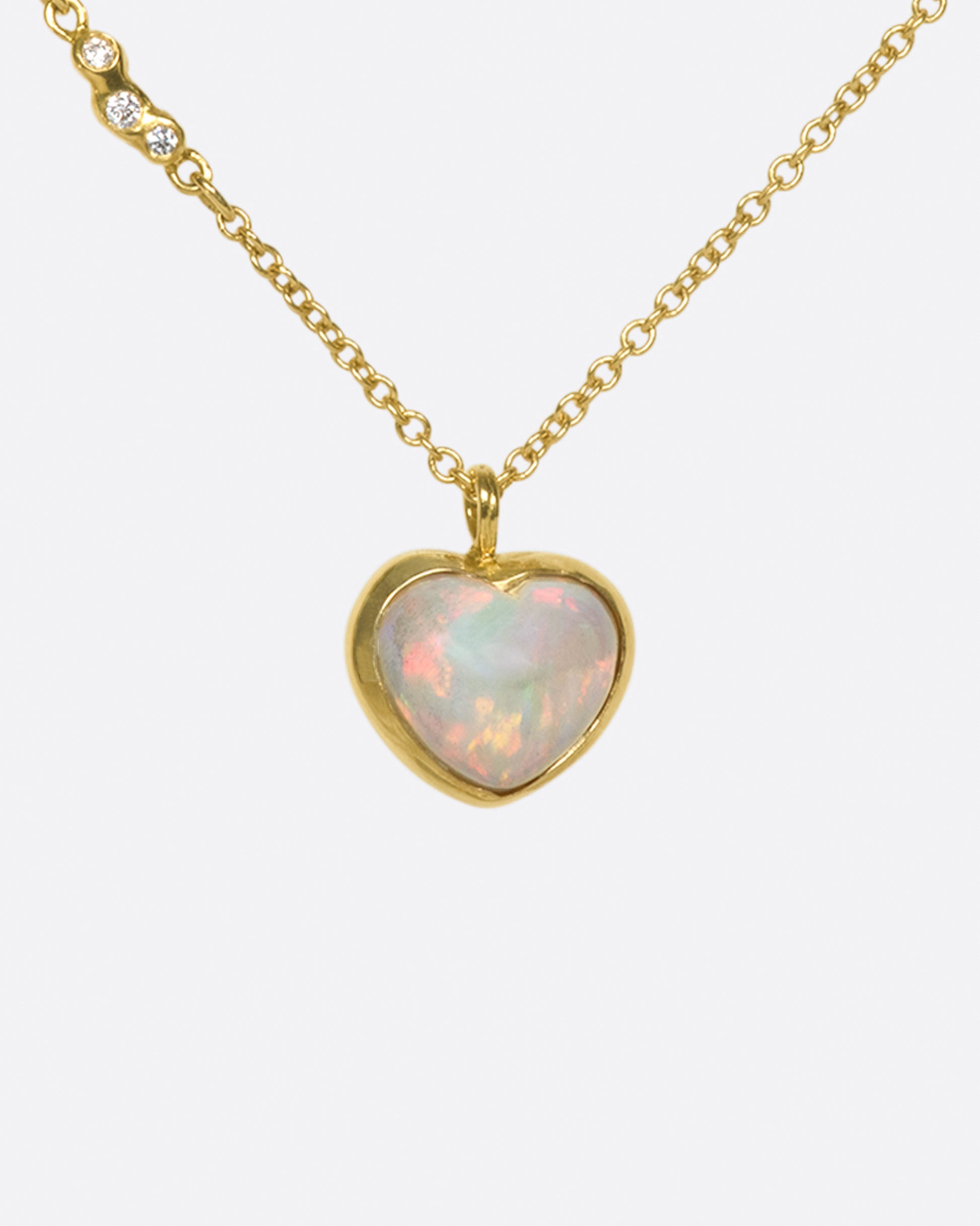 A glorious, bubble-like, Australian opal heart pendant whose fire can be seen from every angle.