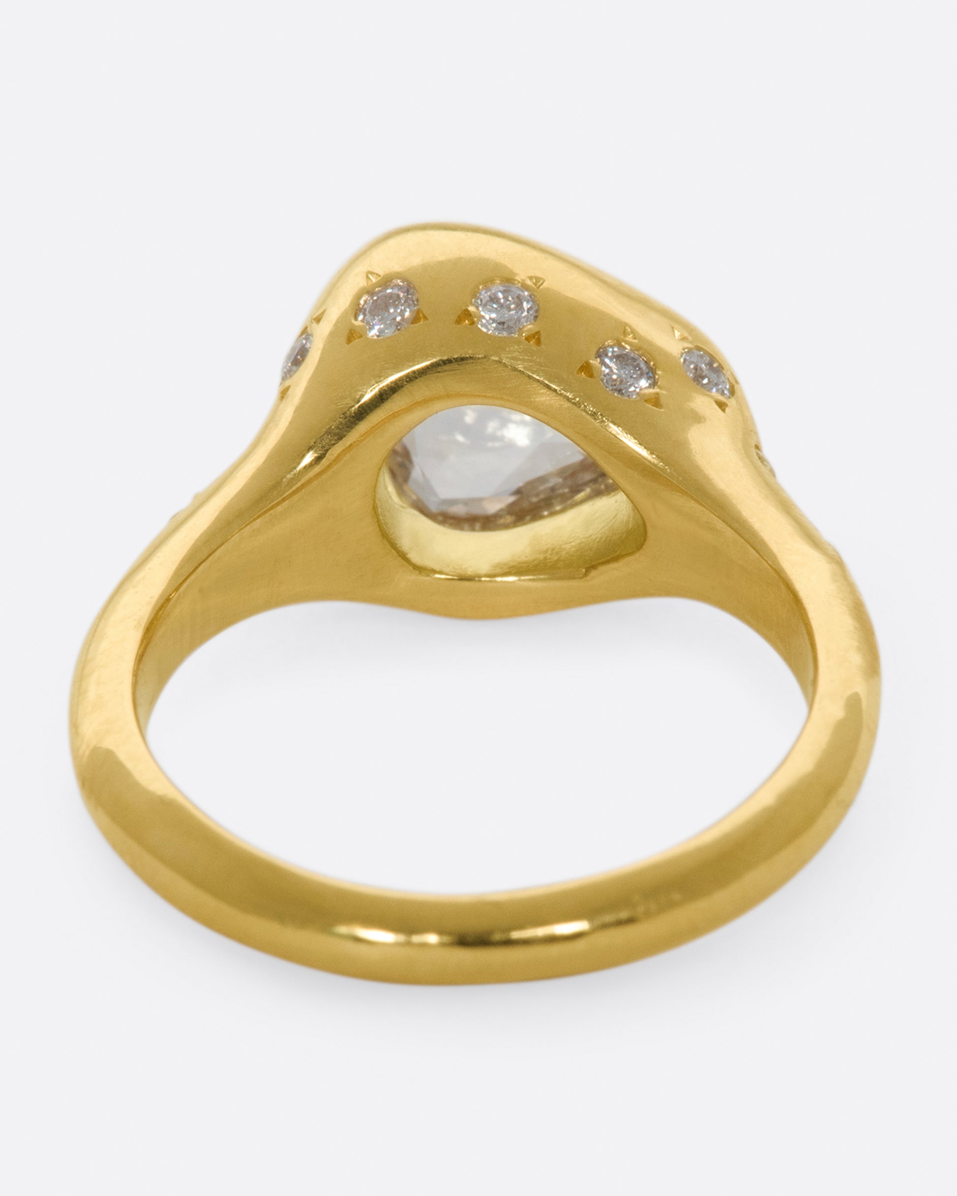 A glorious triangular, rose cut diamond sits on its side giving this ring an east-west sensibility.