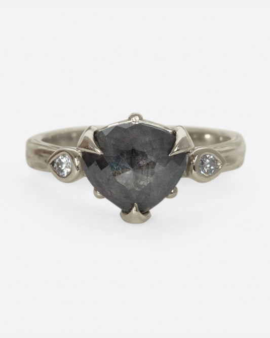 A dark, glamorous ring with a rose cut, heart-shaped diamond embraced in pointed claw settings.