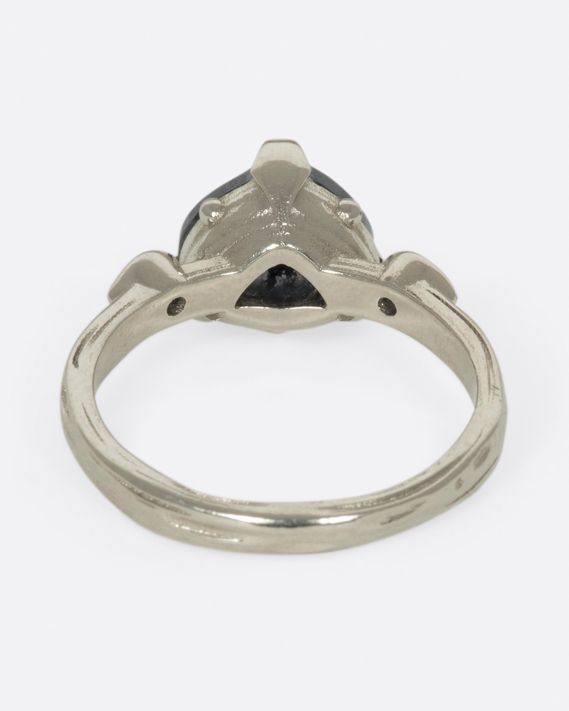 A dark, glamorous ring with a rose cut, heart-shaped diamond embraced in pointed claw settings.