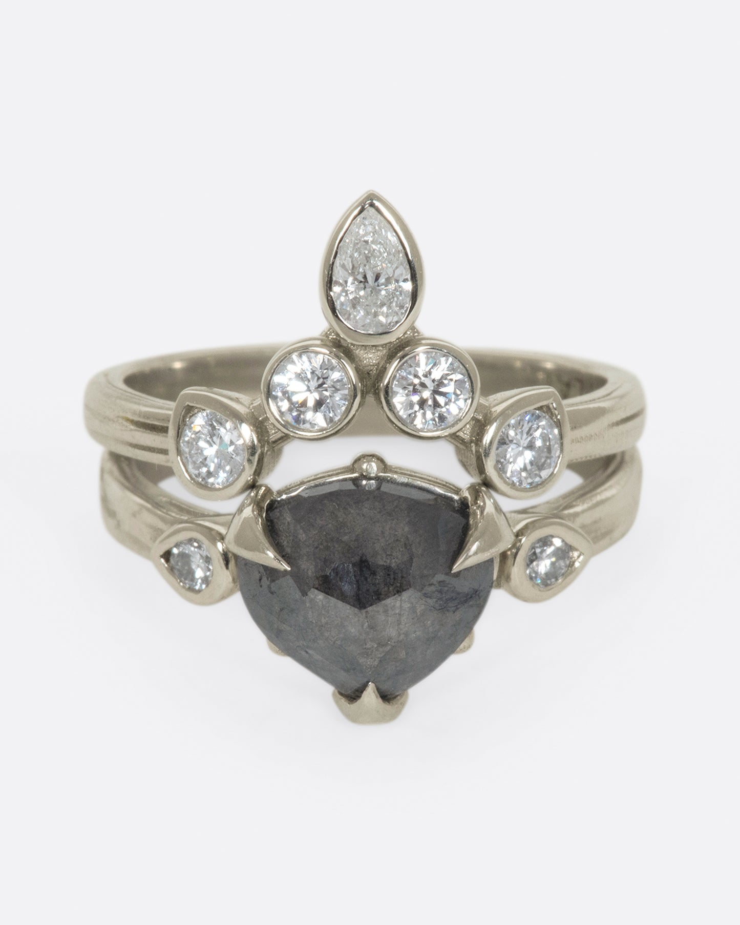 A dark, glamorous ring with a rose cut, heart-shaped diamond embraced in pointed claw settings.