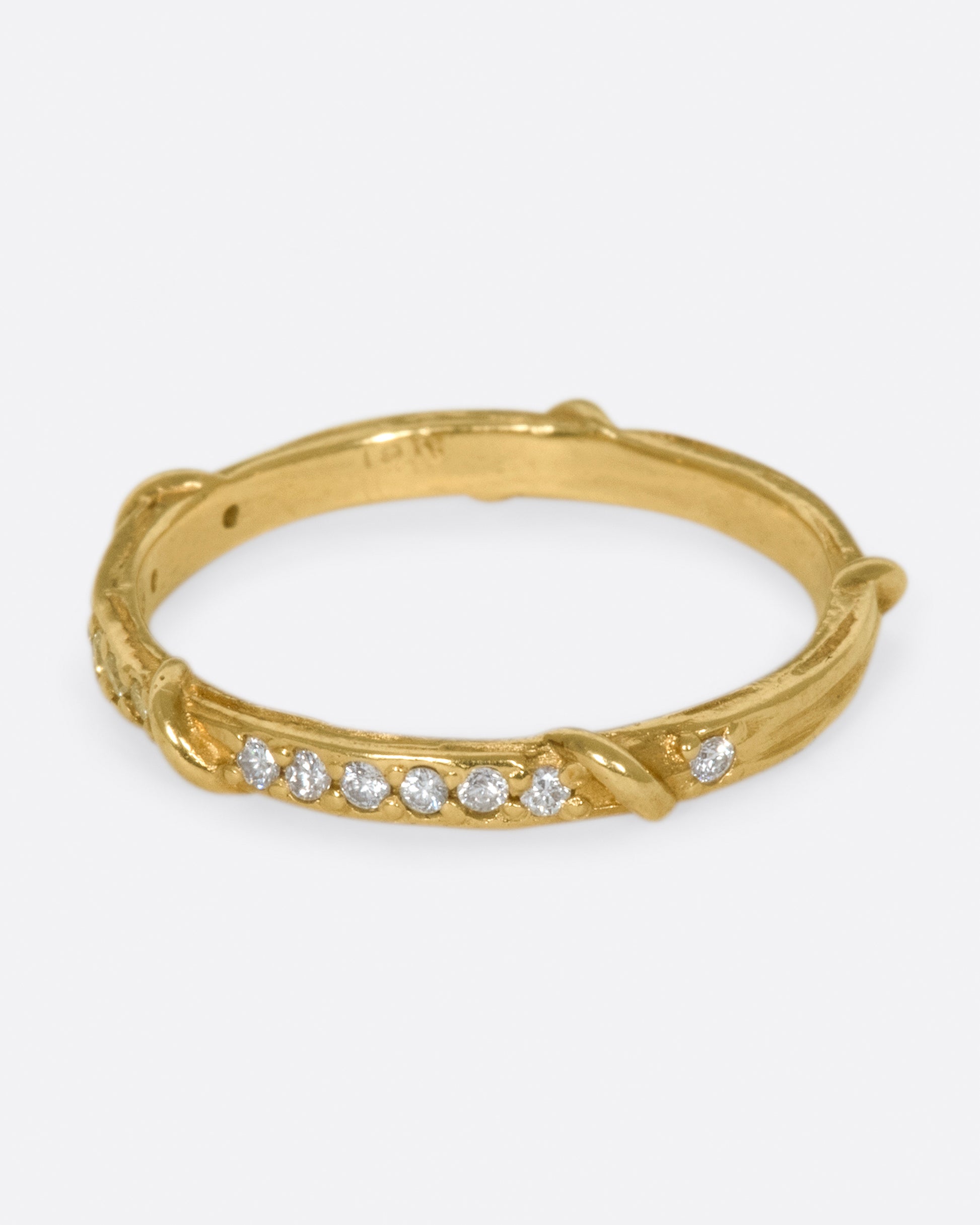 Studded halfway around with diamonds, this band is a twist on a classic with an organic edge.