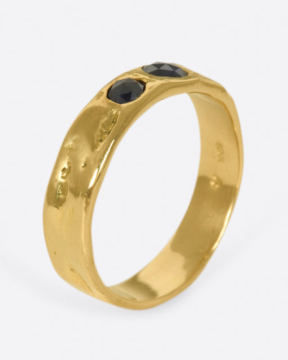 Yellow gold black diamond band, angled view of the band showing the black diamonds across the top