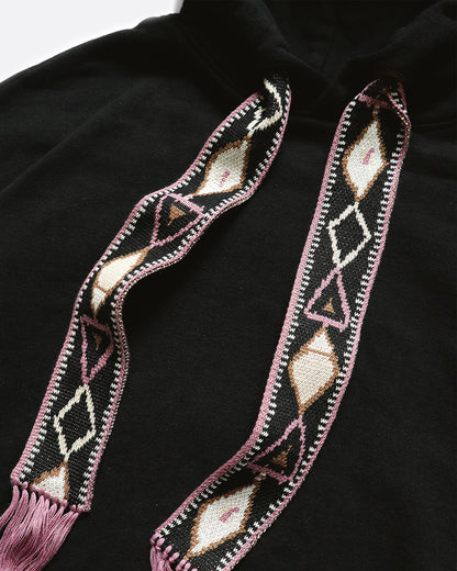 Black hooded sweatshirt with woven tassel drawstrings, close view of the woven drawstrings