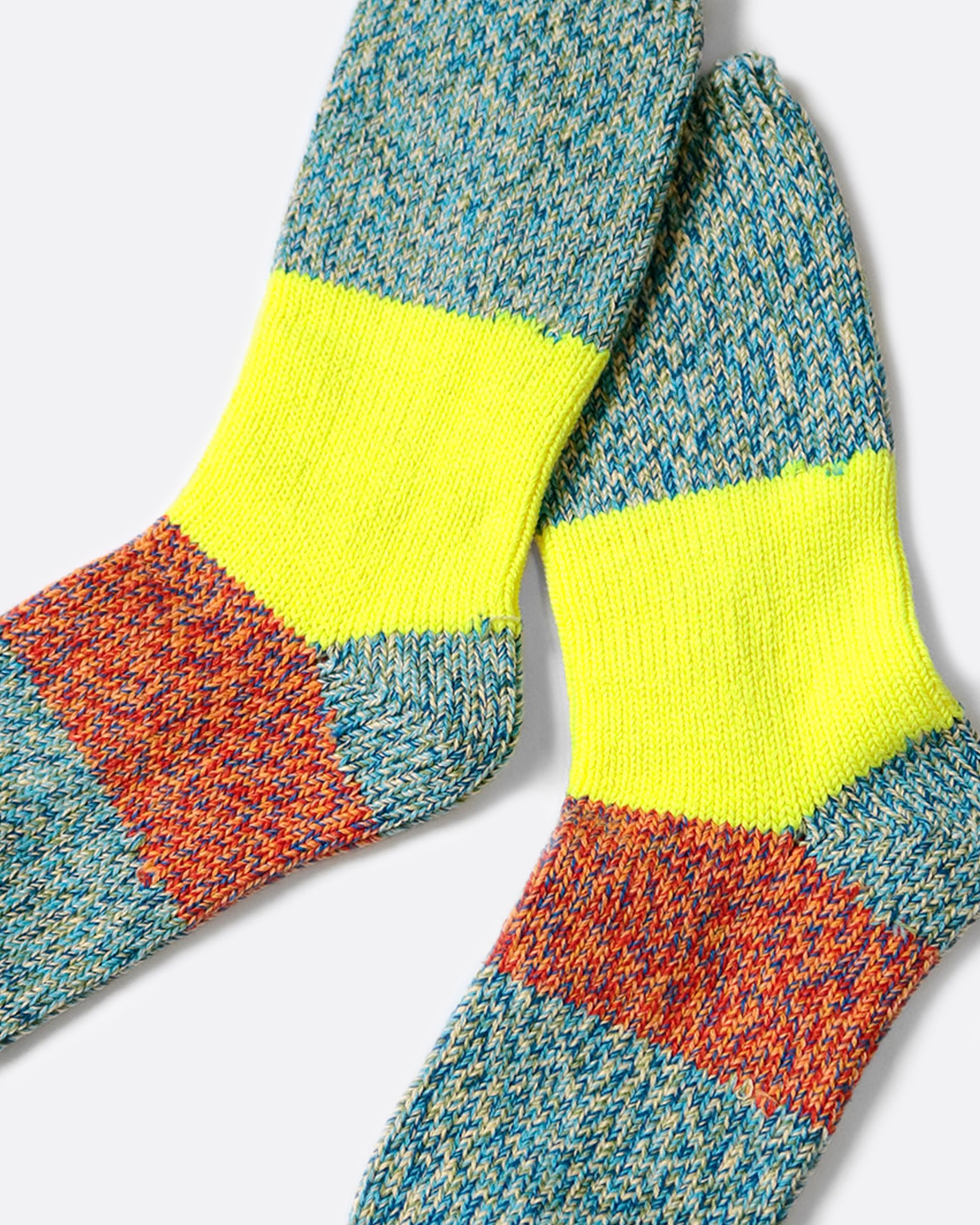 These thick turquoise blue socks are rich and fluffy with wide neon yellow and orange stripes down the center.