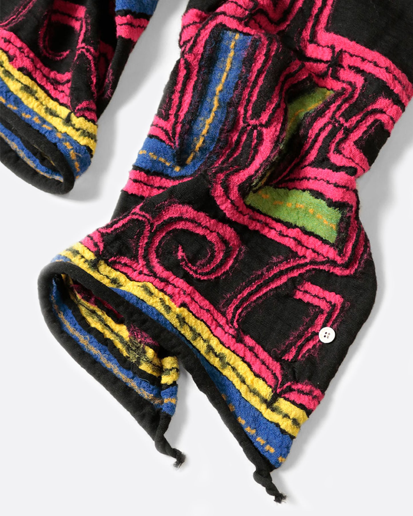 A black scarf with a neon pink Ainu pattern