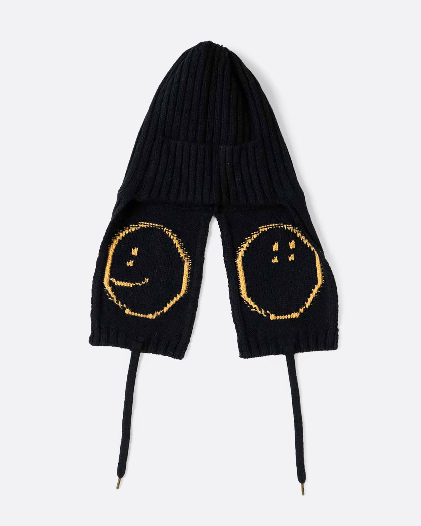 A black knit hat with yellow smilie faces on either ear flap. View from the back laying flat.