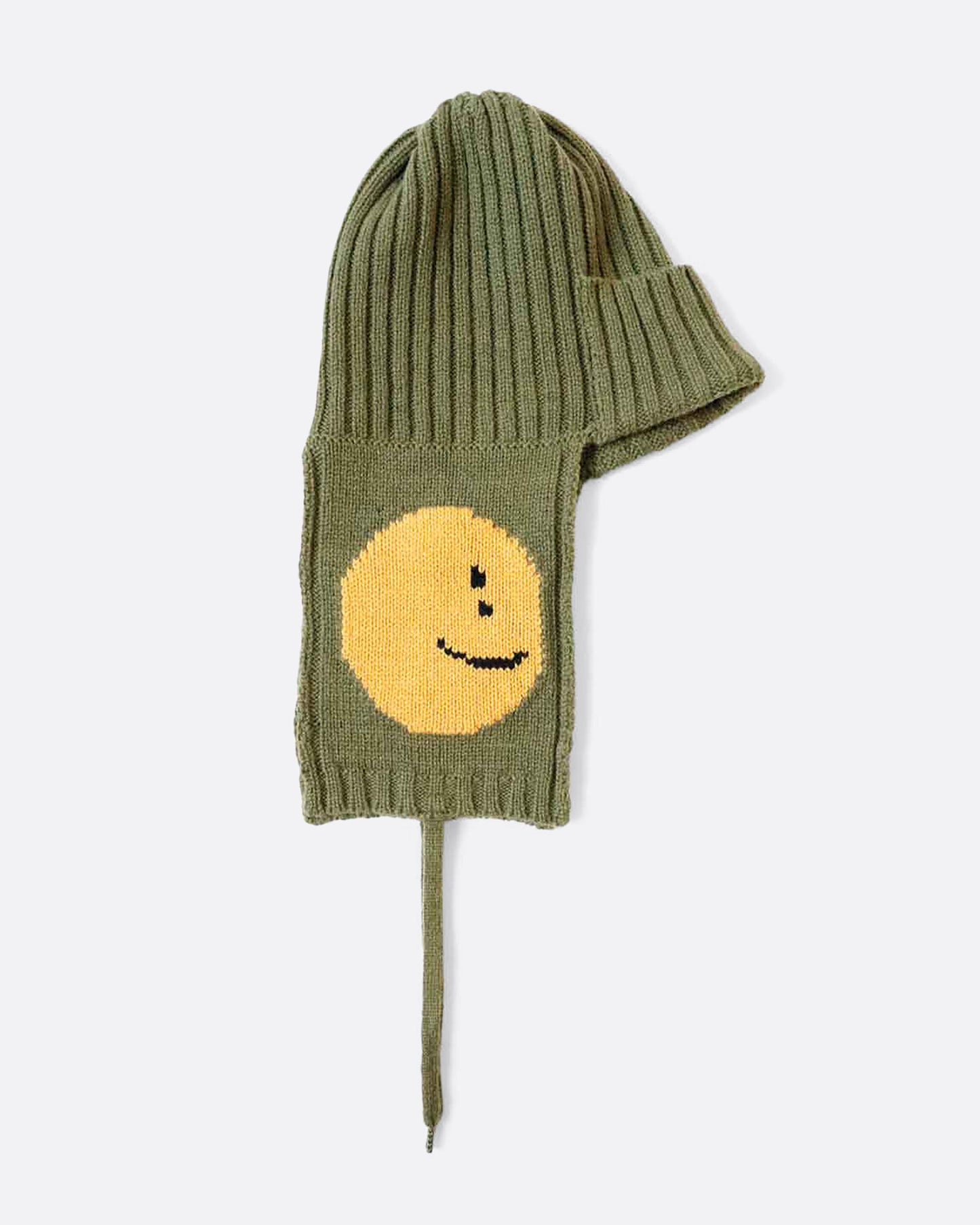 A khaki green hat with yellow smilie faces on either ear flap. View from the side, laying flat.