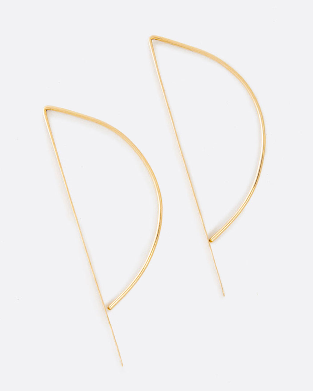 Called the bow hook earrings, this unusual shape is a unique take on a hoop earring with a flat edge that catches the light.