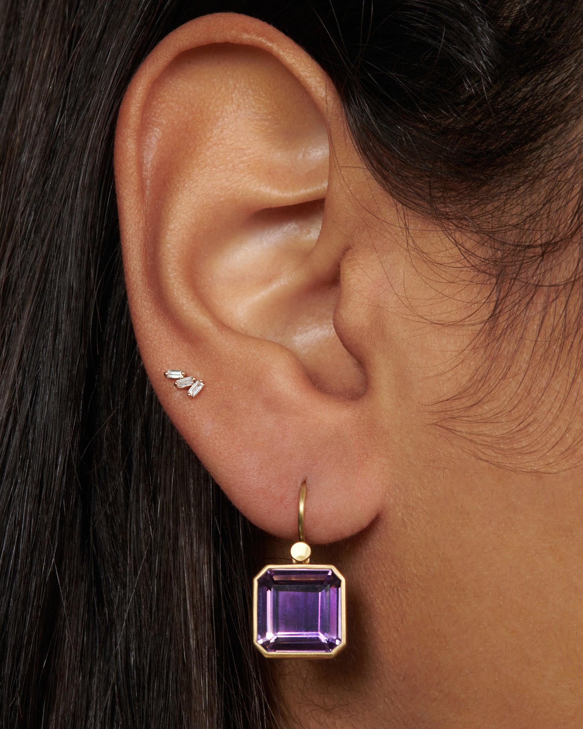 A pair of 18k gold drops with amethyst cubes. The octagonal shape adds extra dimension to the deep purple stone, making it change colors when viewed from different angles.