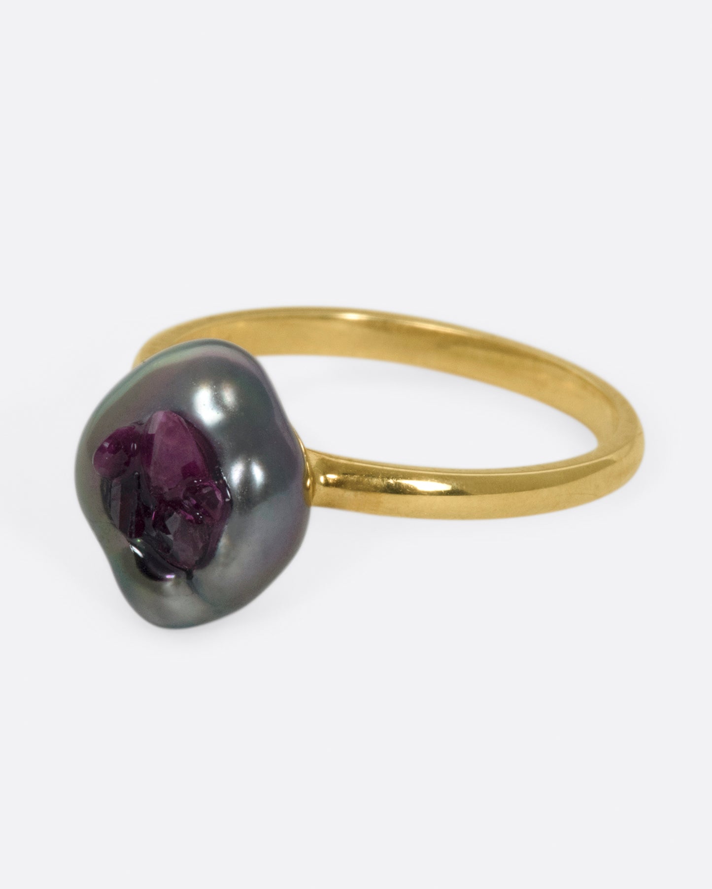 Yellow gold freshwater pearl ring lined with reclaimed rubies. View from the side.