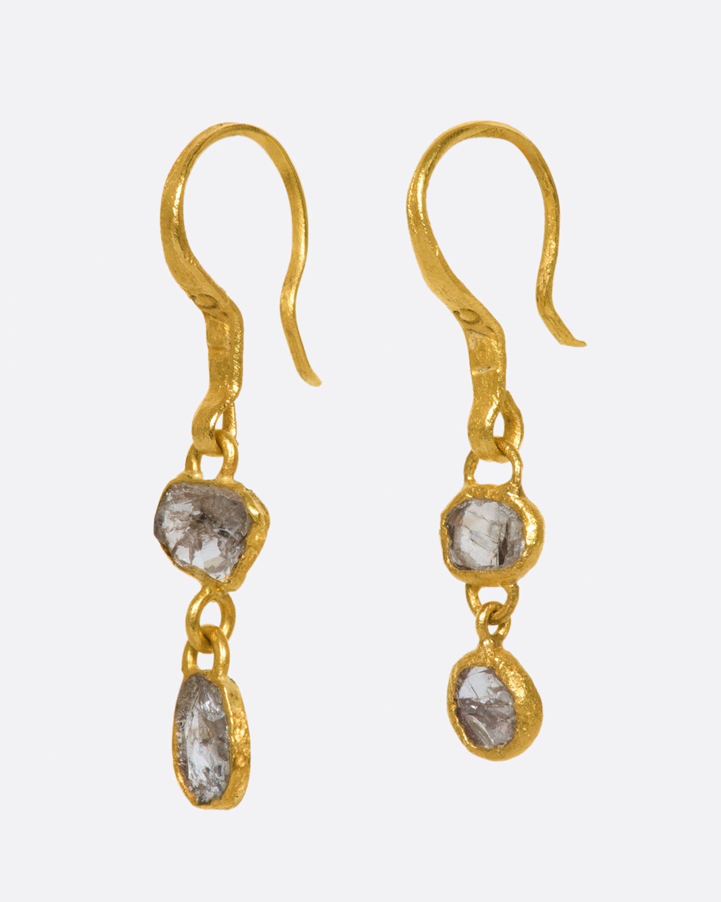 These natural grey Borneo diamond drops are wrapped around their edges in 22k gold, so you can see the unique, asymmetrical stones from both sides.